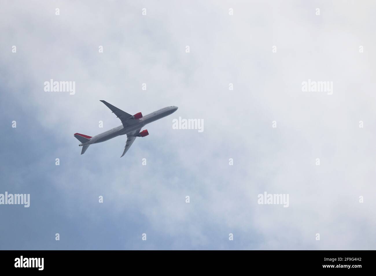 Airplane flying in the blue sky with white clouds. Passenger plane at ...