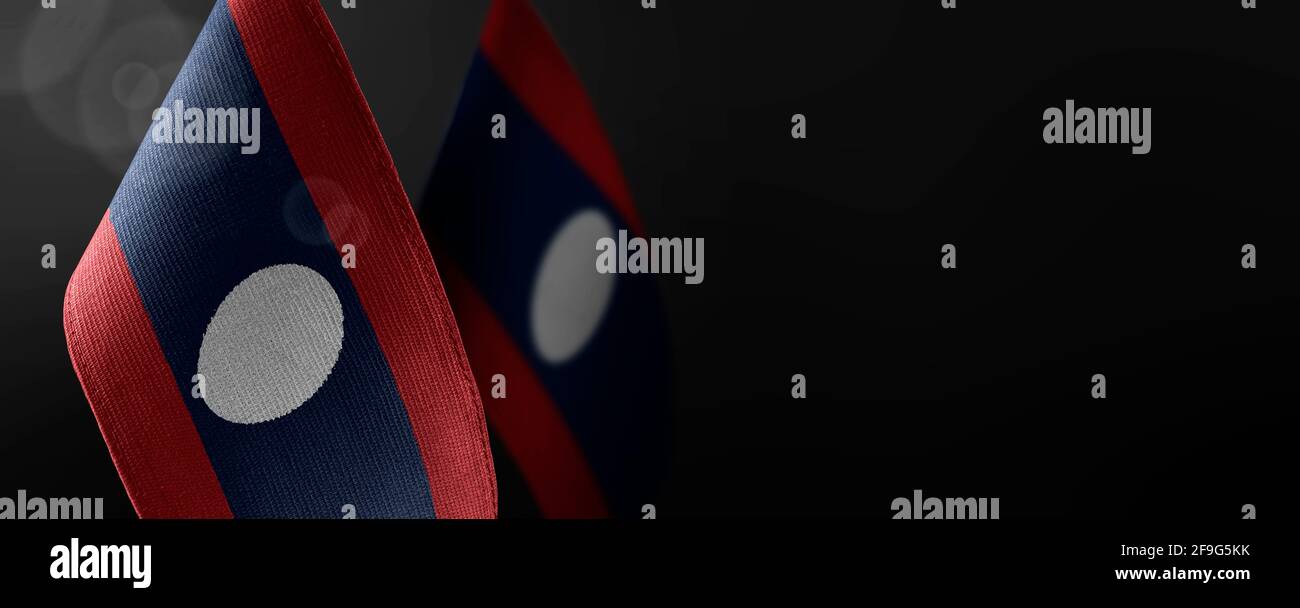 Small national flags of the Laos on a dark background Stock Photo