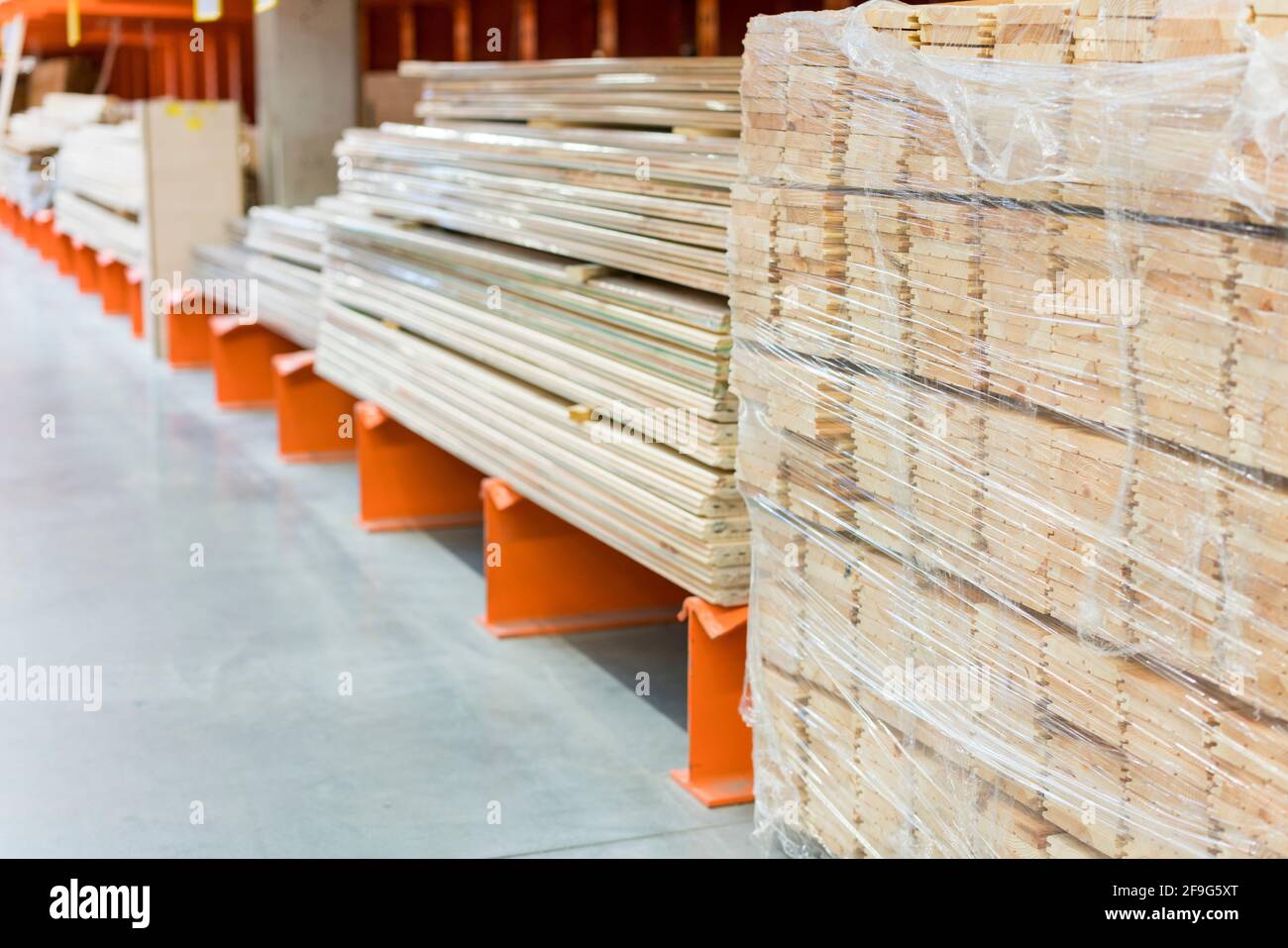 Many wooden planks in hardware store. Stacks of wooden planks at
