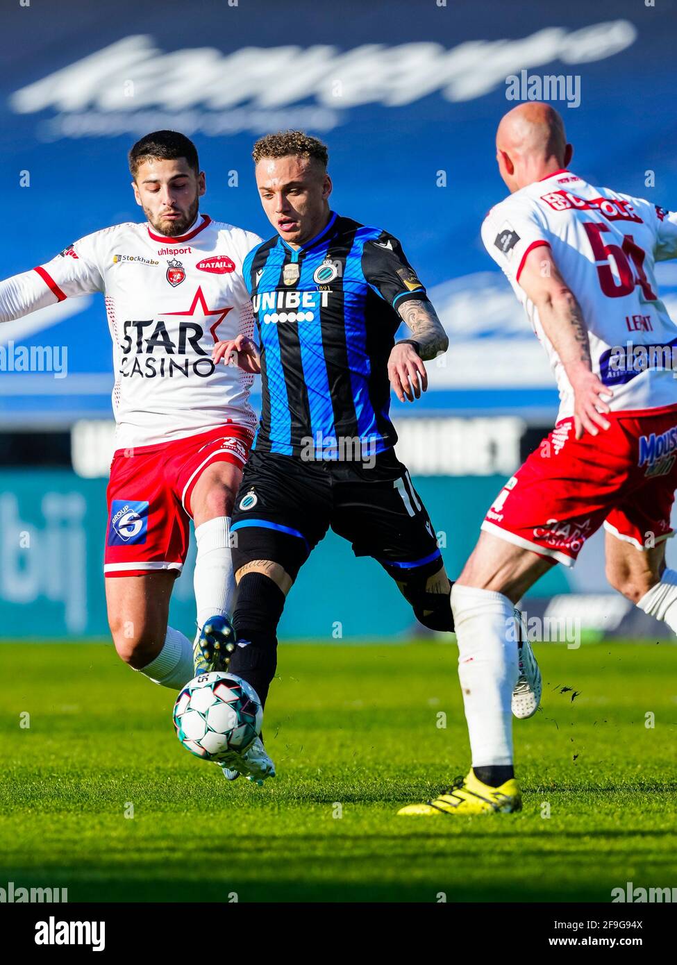 BRUGES, BELGIUM - APRIL 18: Bruno Xadas of Excelsior Mouscron, Noa Lang of Club Brugge, Christophe Lepoint of Excelsior Mouscron during the Pro League Stock Photo