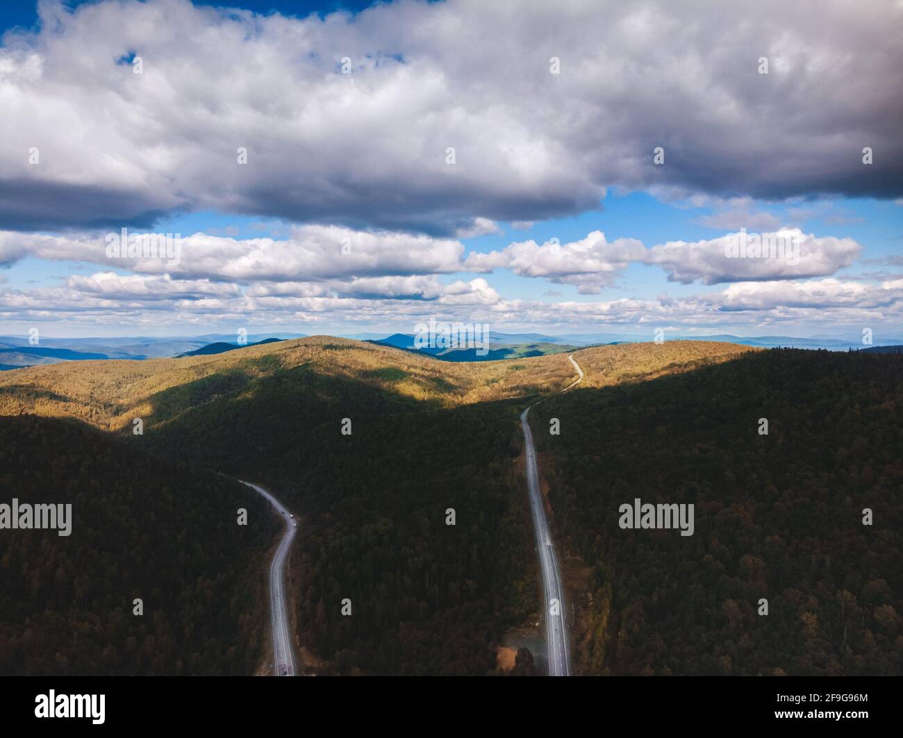 Overhead aerial top view. Mountain road in the forest. drone shooting ...