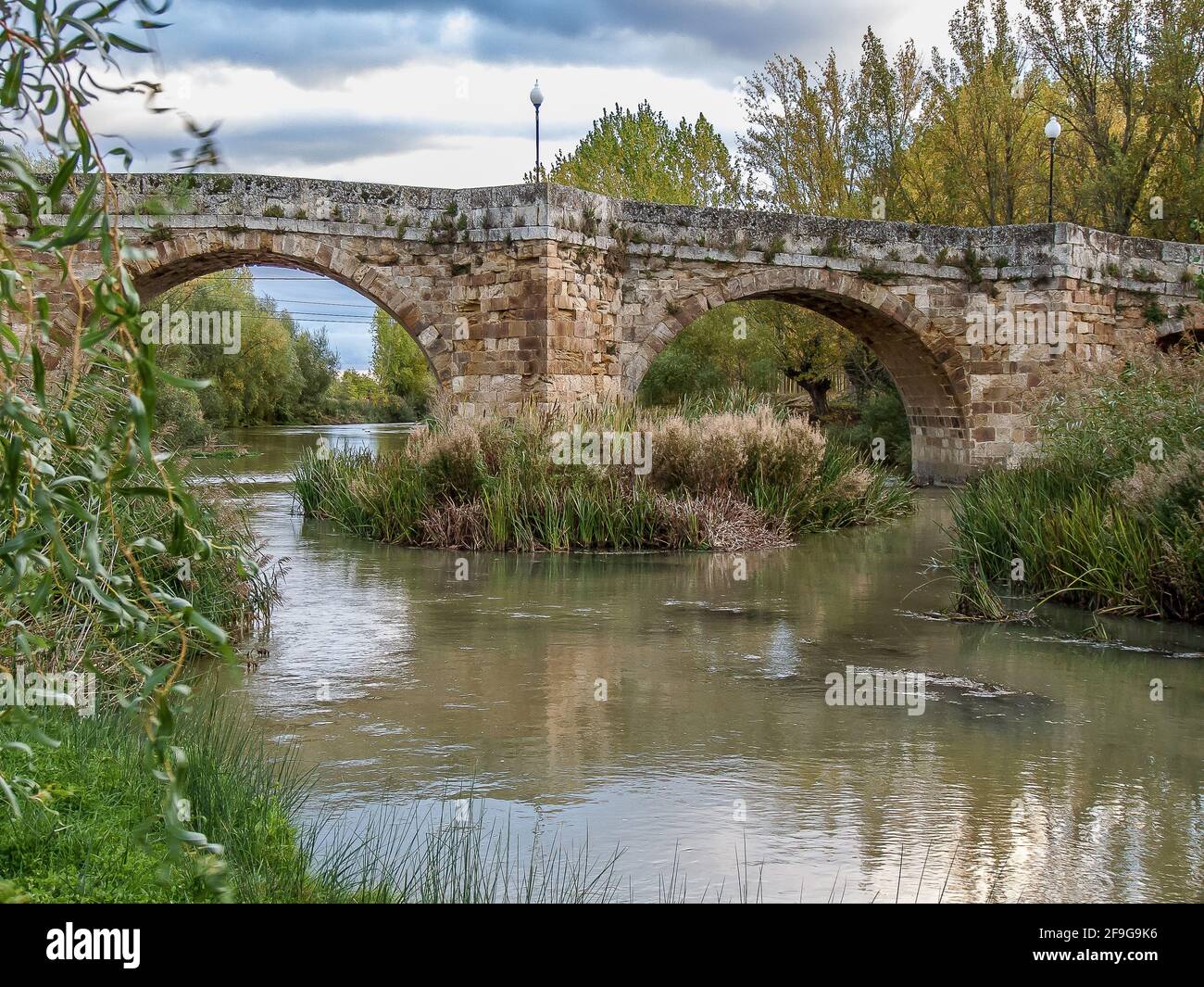 Roman bridge Puente Canto over the river Cea along the camino of Santiago in Sahagun, Spain, Okt 22, 2009 Stock Photo