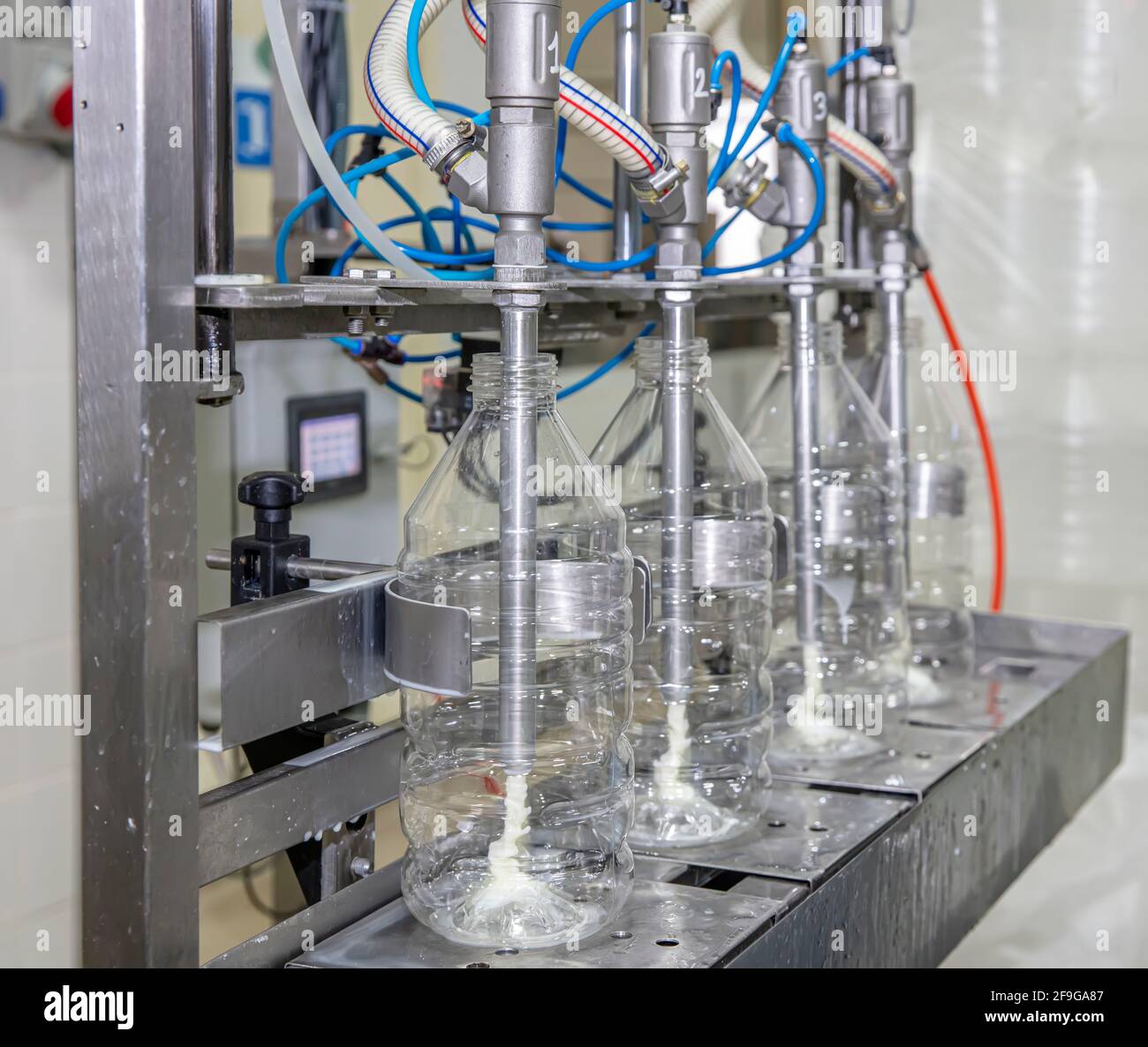 Filling milk into plastic bottles at the factory. equipment in dairy