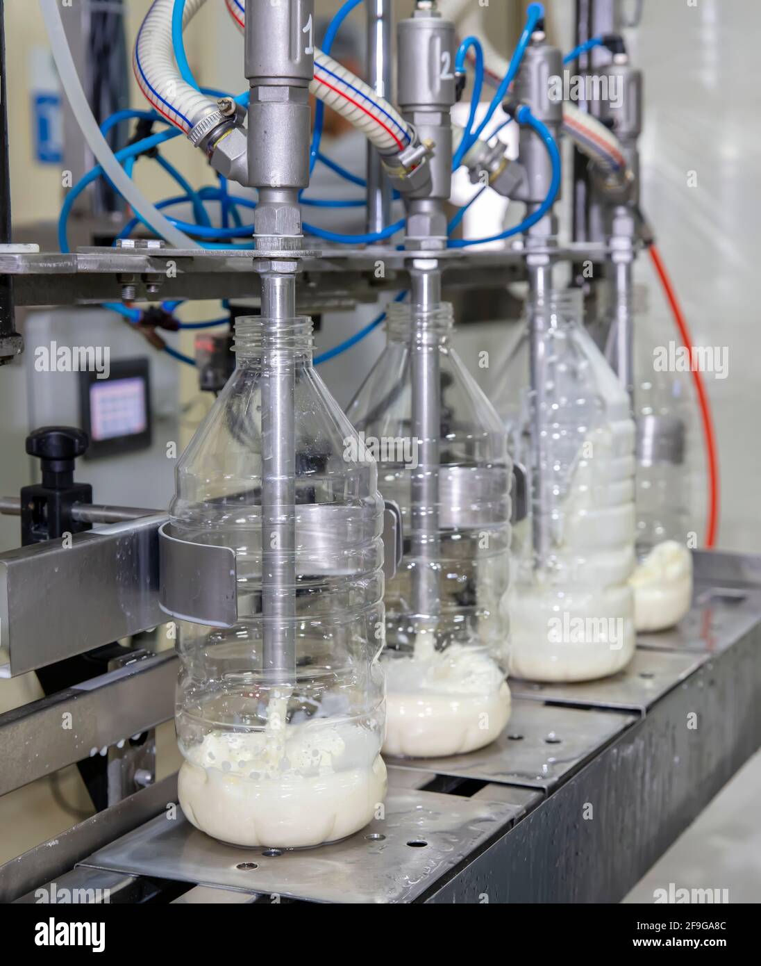Filling milk into plastic bottles at the factory. equipment in dairy