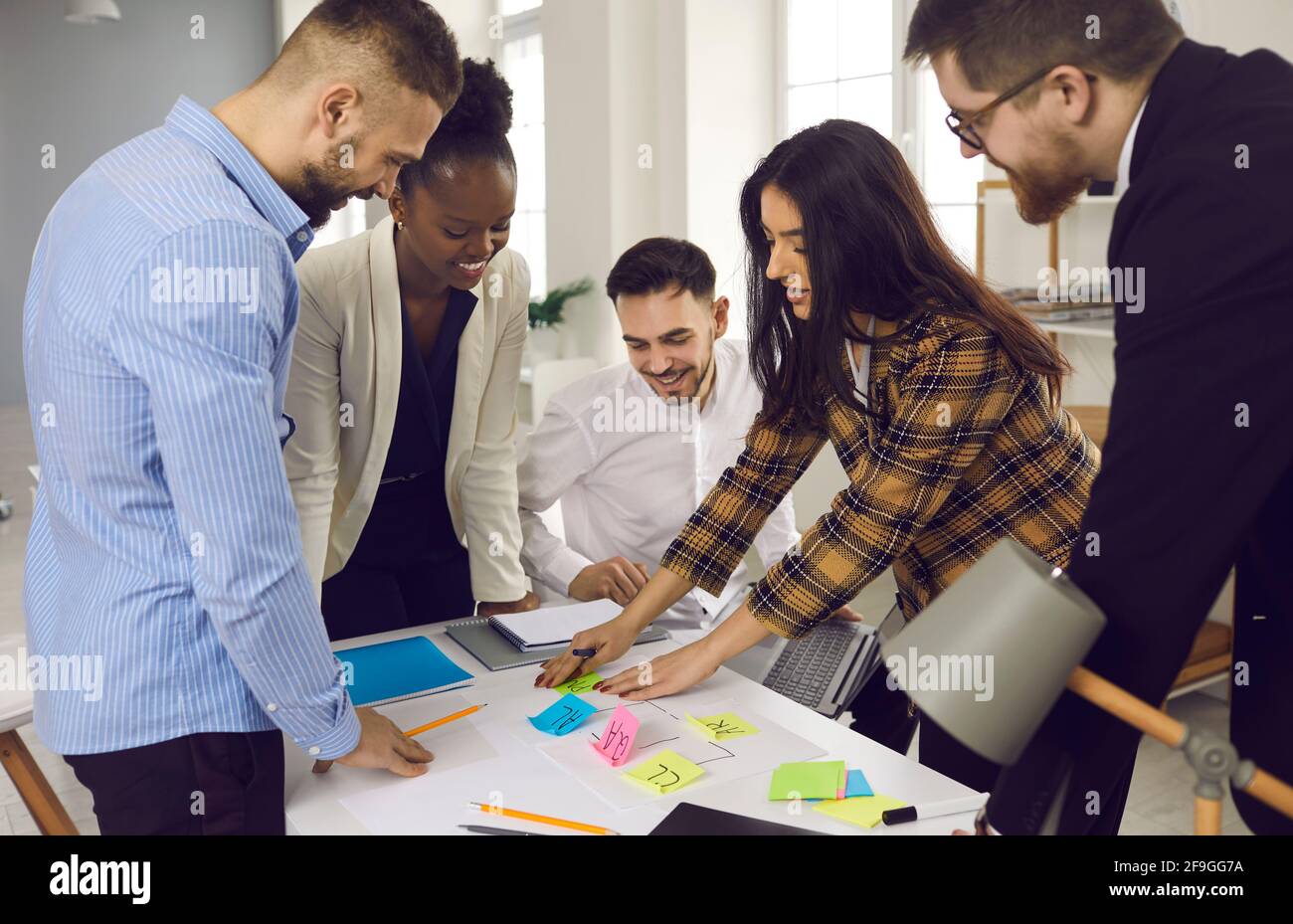 Mixed race diverse smart business team brainstorming planning use color sticker Stock Photo