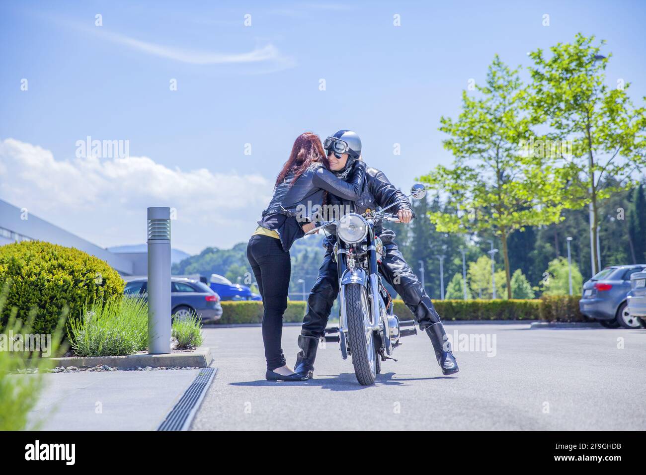A female hugging his boyfriend on a motorcycle Stock Photo Alamy