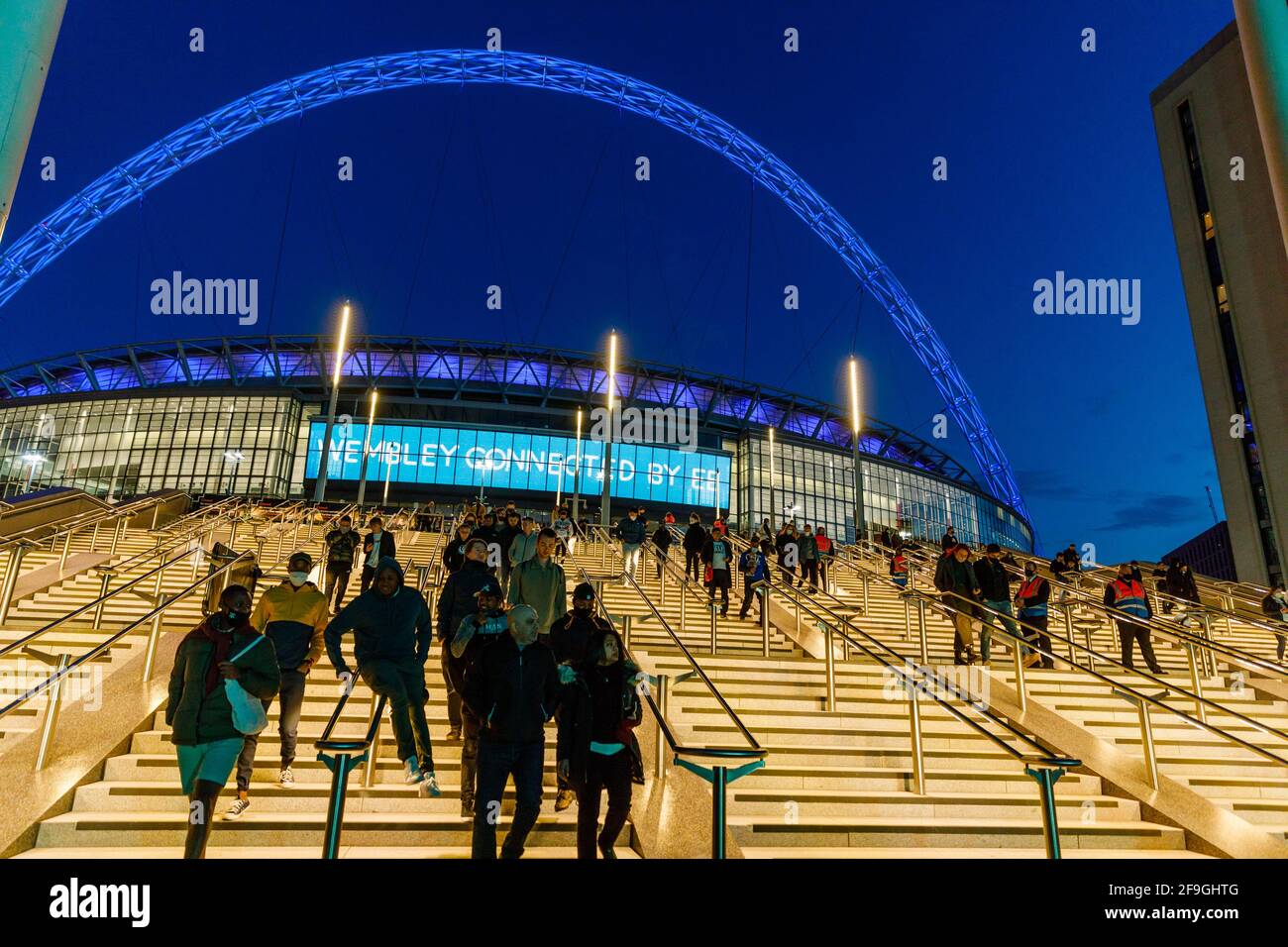 Wembley Stadium, Wembley Park, UK. 18th April 2021.Crowds leaving Wembley Stadium on the newly finished Olympic Steps following todays FA Cup semi-final between Leicester City and Southampton.  4,000 local residents and NHS Staff attended the match at Wembley, the largest crowd to have watched a football match in a major British stadium for more than 12 months. Amanda Rose/Alamy Live News Stock Photo