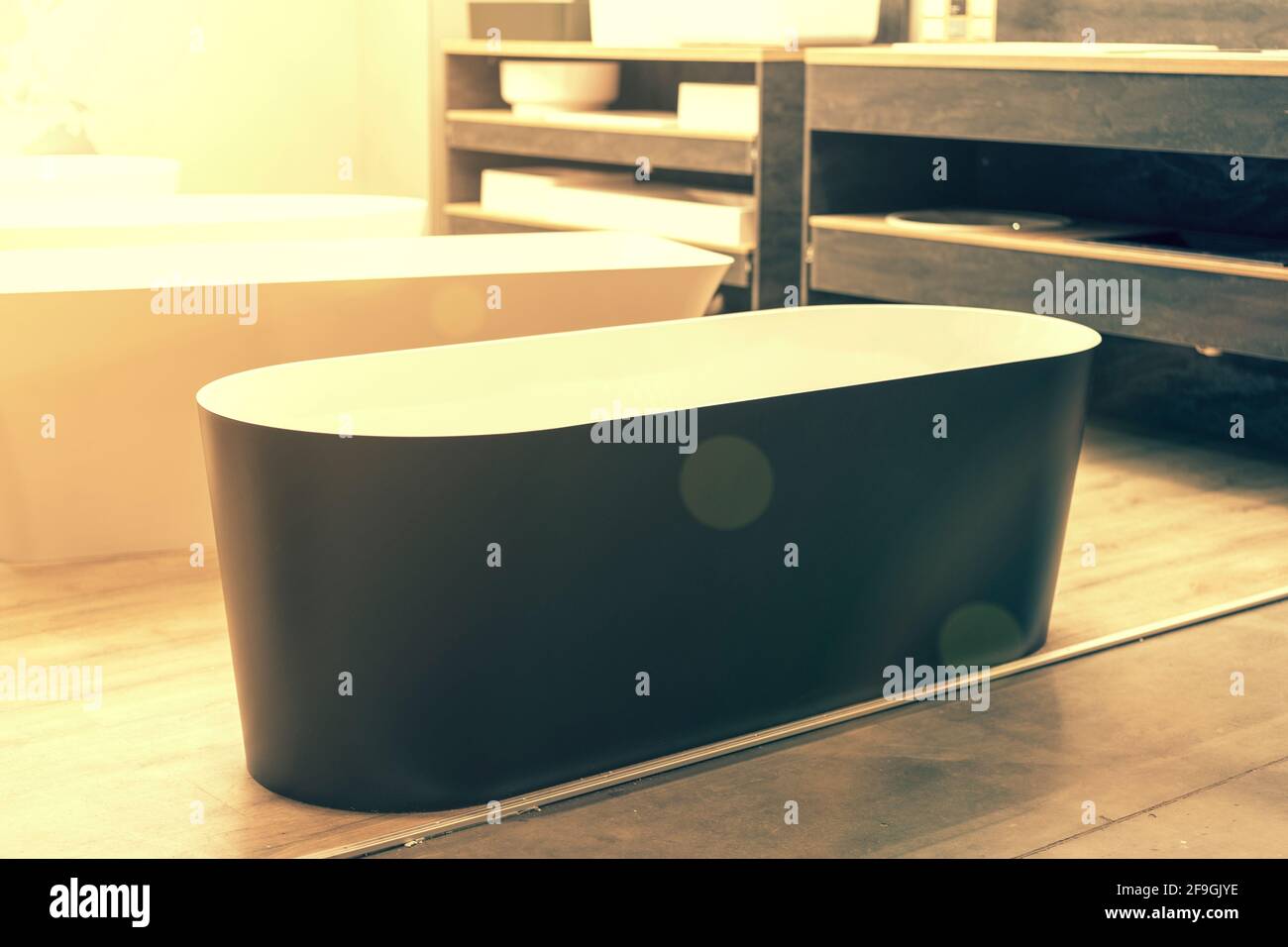 Black bathtub at a hardware store. Sanitary engineering shop. toned
