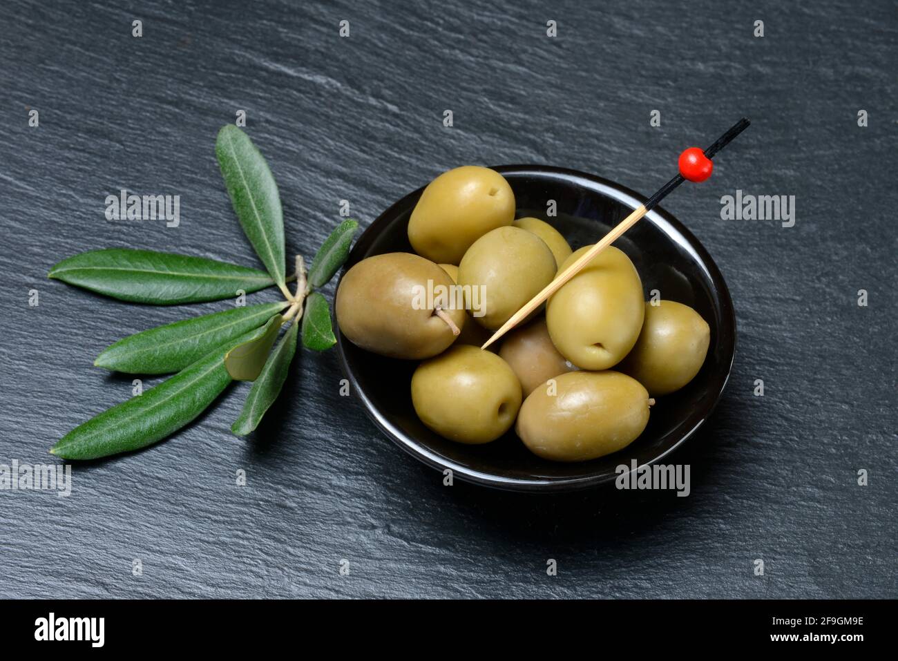 Greek olives from Chalkidiki in small bowls, olive branch, Germany