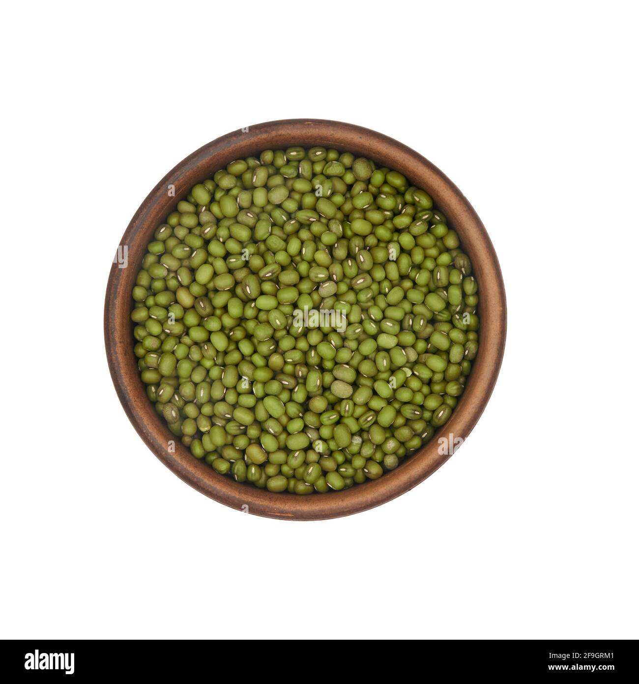 mung beans in simple clay bowl isolated on white background, top view Stock Photo