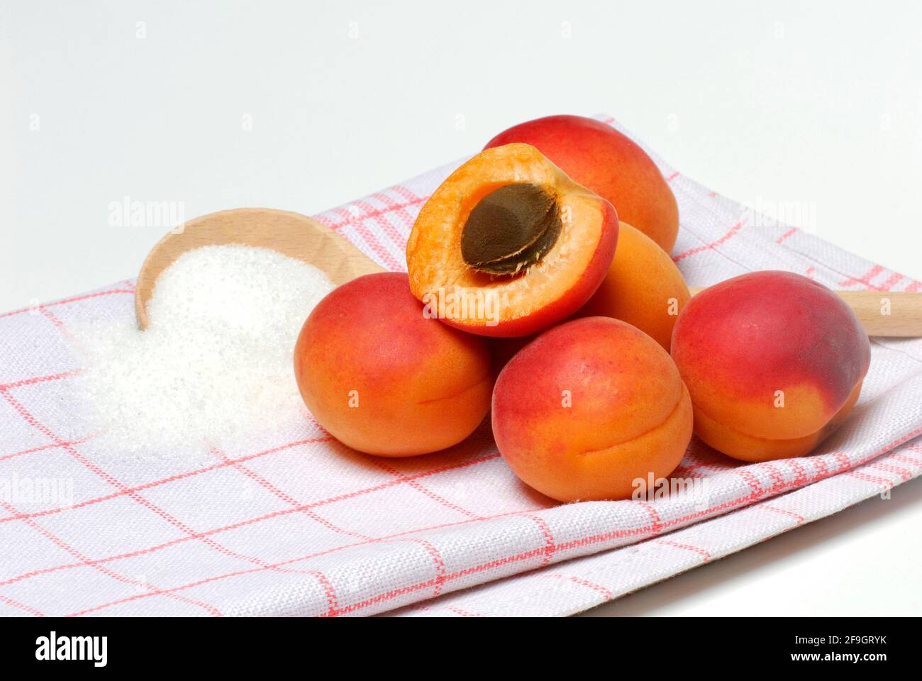 Apricots ( Prunus armeniaca) , Cooking spoon with sugar Stock Photo