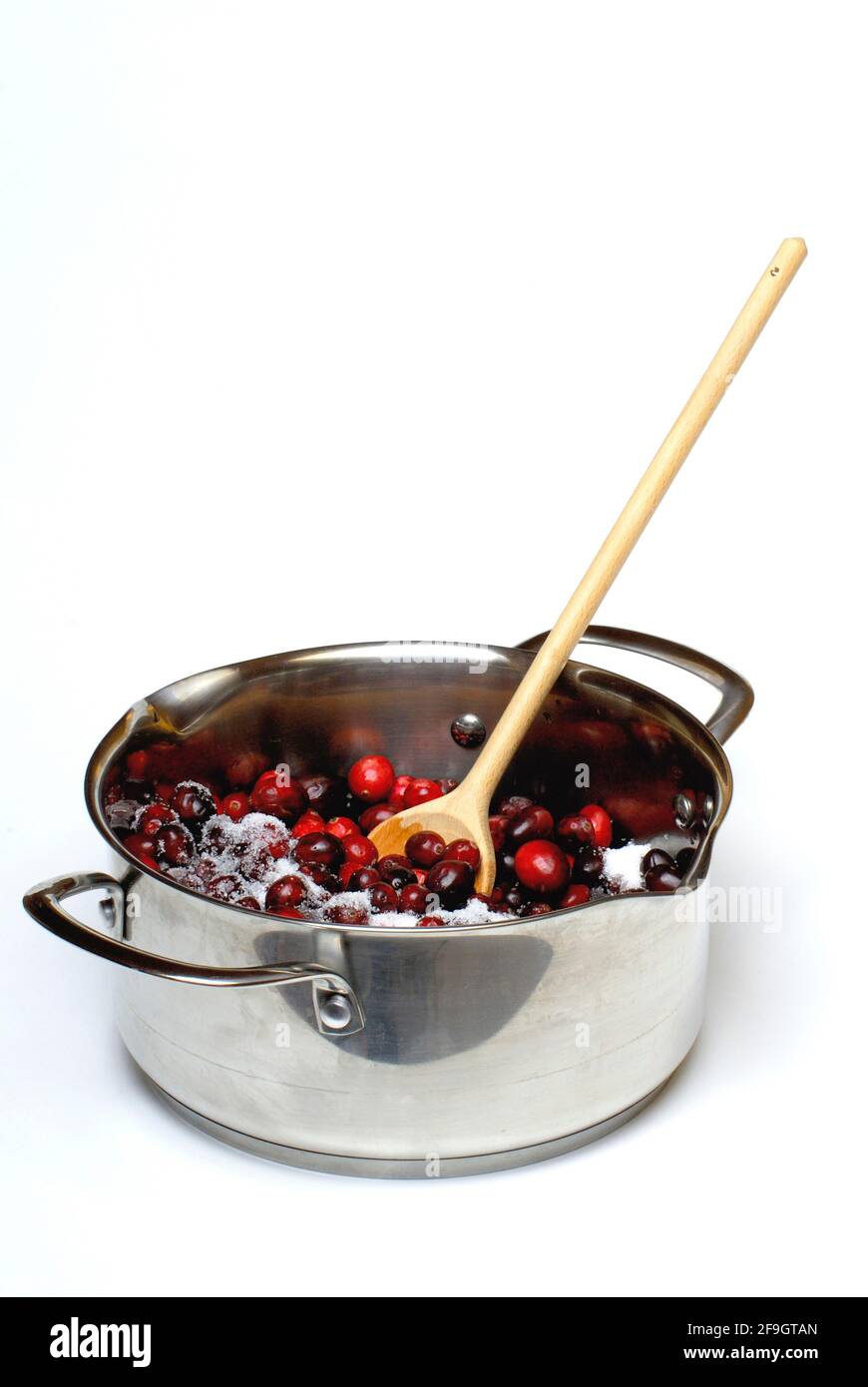 Cranberries with sugar (Vaccinium macrocarpon) , cranberry, , wooden spoon, cooking spoon, granulated sugar, cooking pot, pot Stock Photo