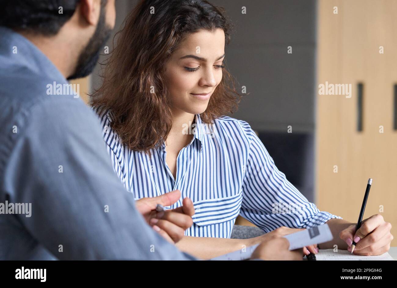 Two sales professionals working together with laptop in office. Stock Photo