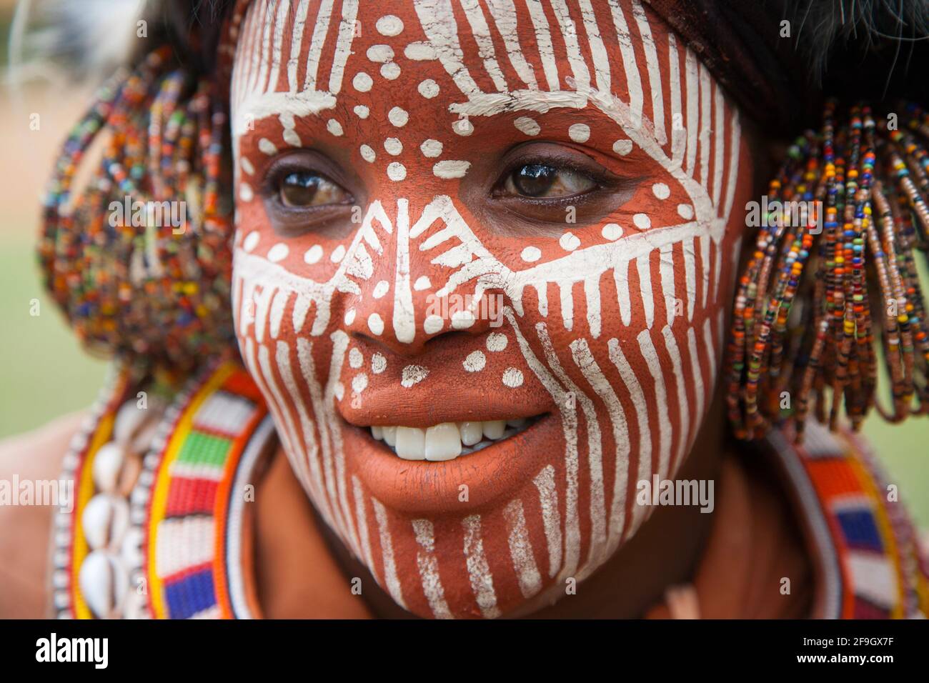 Kikuyu woman with face painting, jewellery and headdress, Kenya Stock