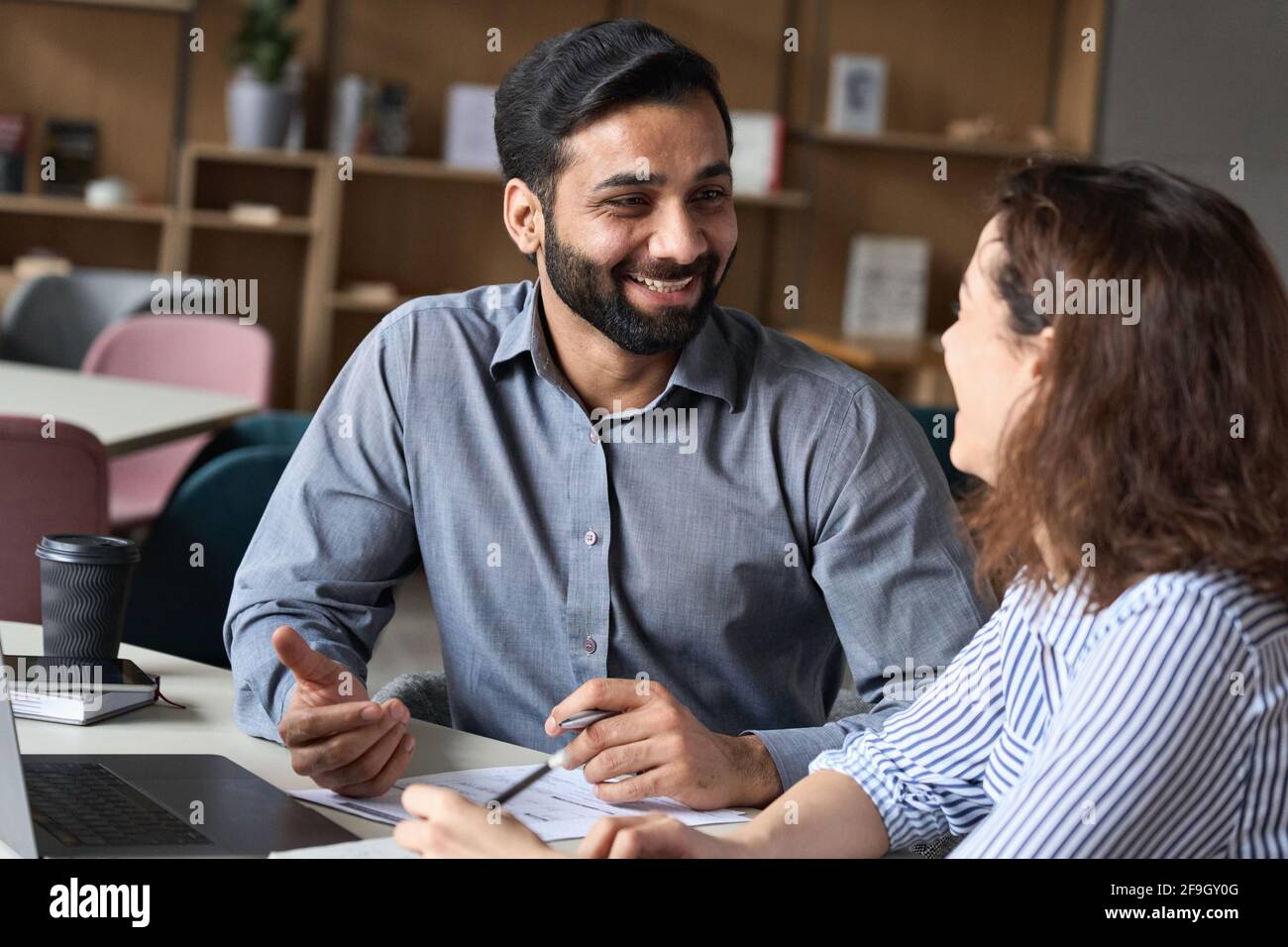 Multiethnic interview of happy smiling hr manager and young professional. Stock Photo
