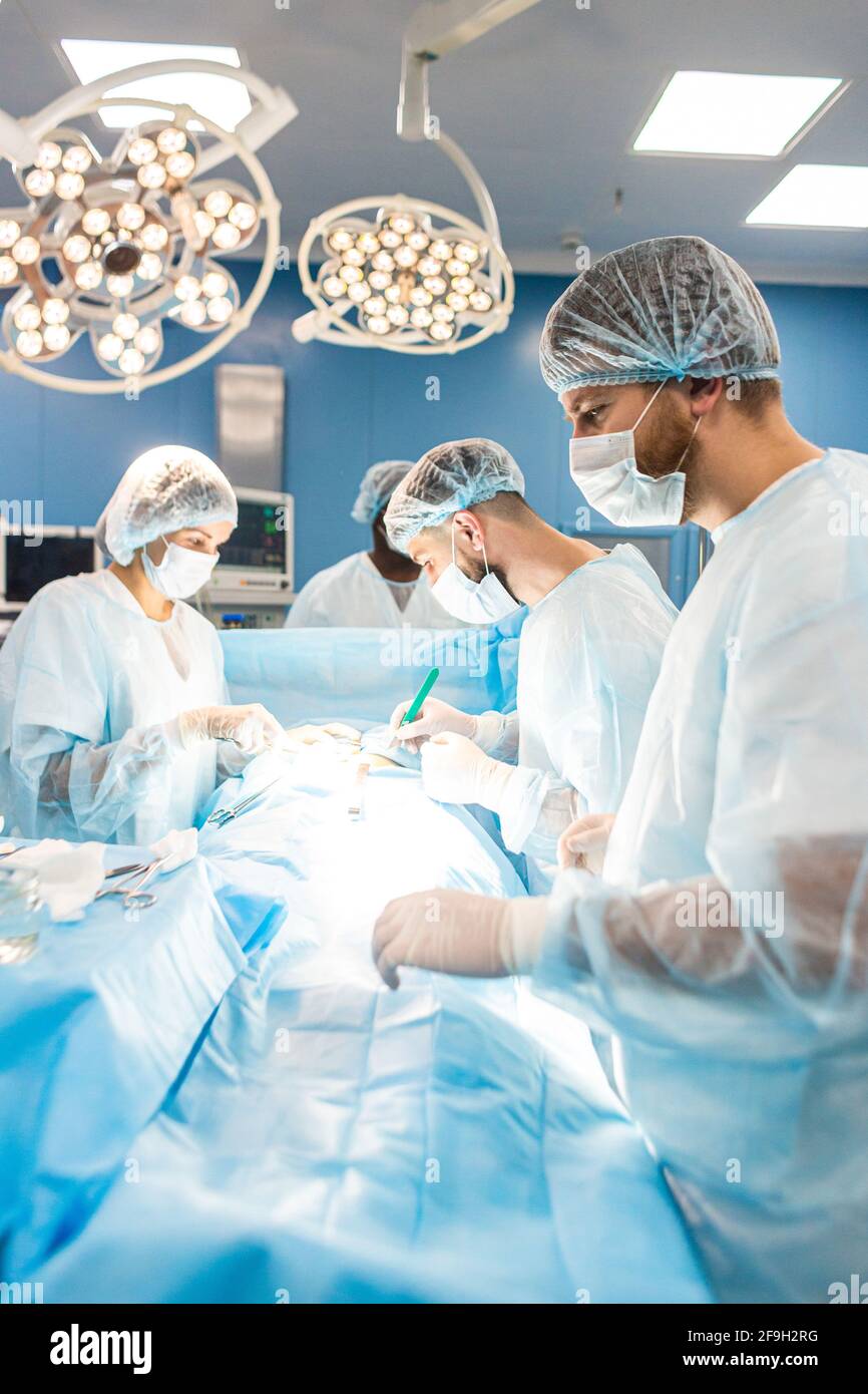 An international team of doctors performs a complex surgical operation ...