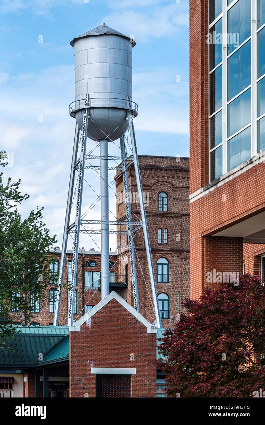 Historic Eagle & Phenix Mill water tower, just beyond the Synovus Centre and Chattahoochee River Club, in Uptown Columbus, Georgia. (USA) Stock Photo
