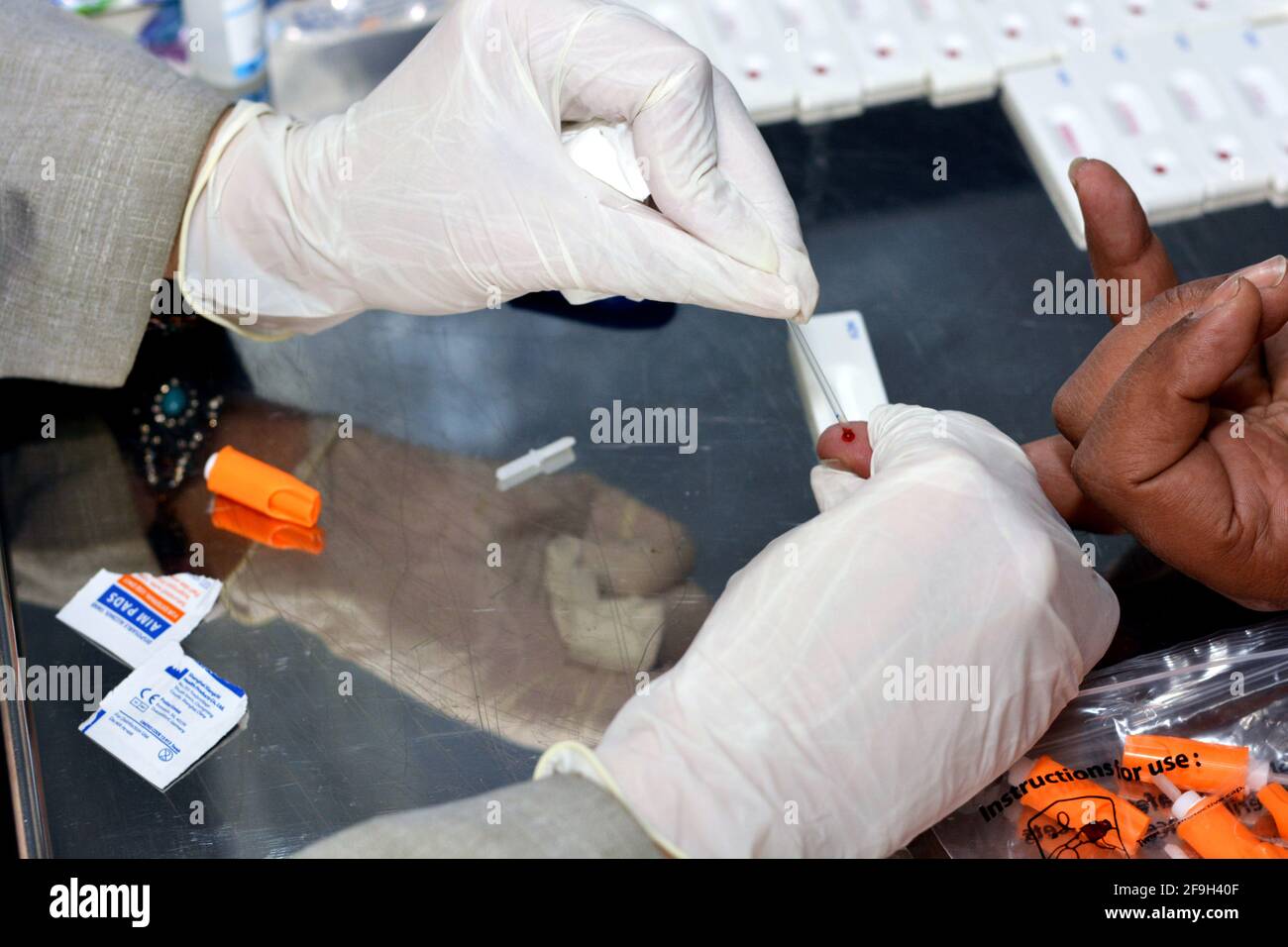 a medical personnel making a rapid test of virus c for a patient , Screening for hepatitis C virus Stock Photo