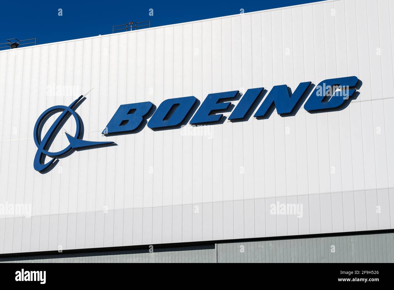 Seattle - April 18, 2021; Boeing Corporation logo on a white building with blue sky in Seattle.  Boeing is a leading aerospace and defence manufacturi Stock Photo