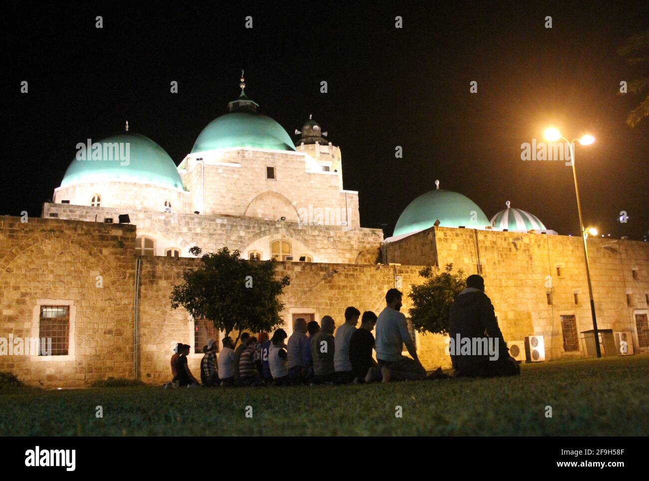 Tripoli, Lebanon. 18th Apr, 2021. People perform evening prayers during the Islamic holy month of Ramadan outside a mosque in Tripoli, Lebanon, on April 18, 2021. Credit: Khaled/Xinhua/Alamy Live News Stock Photo