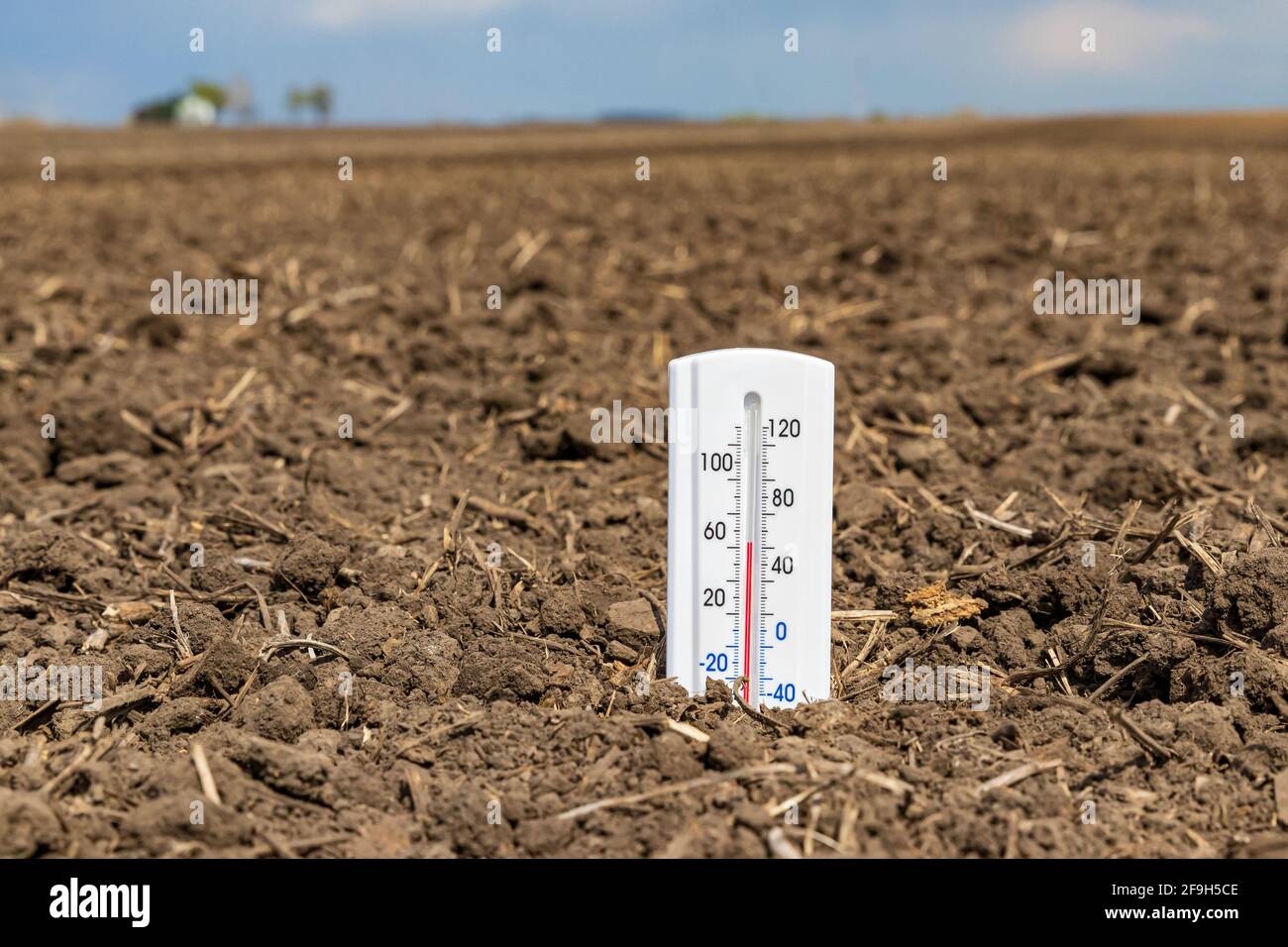 Thermometer is soil of farm field. Soil temperature, planting season