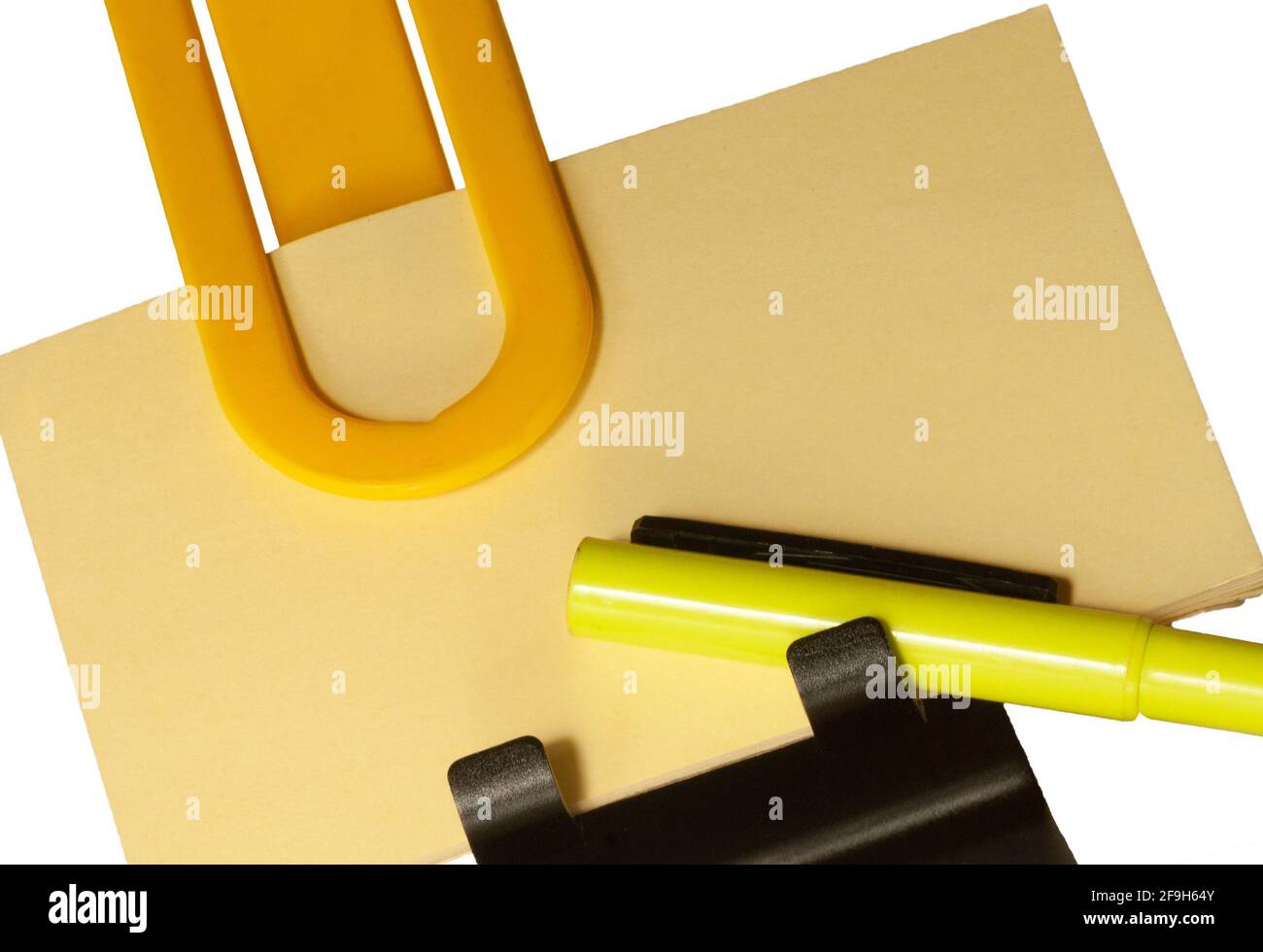 A memo so you don't forget. It is giant and bright yellow. Write it down with a  marker and clip the paper with an oversize paper clip. Stock Photo