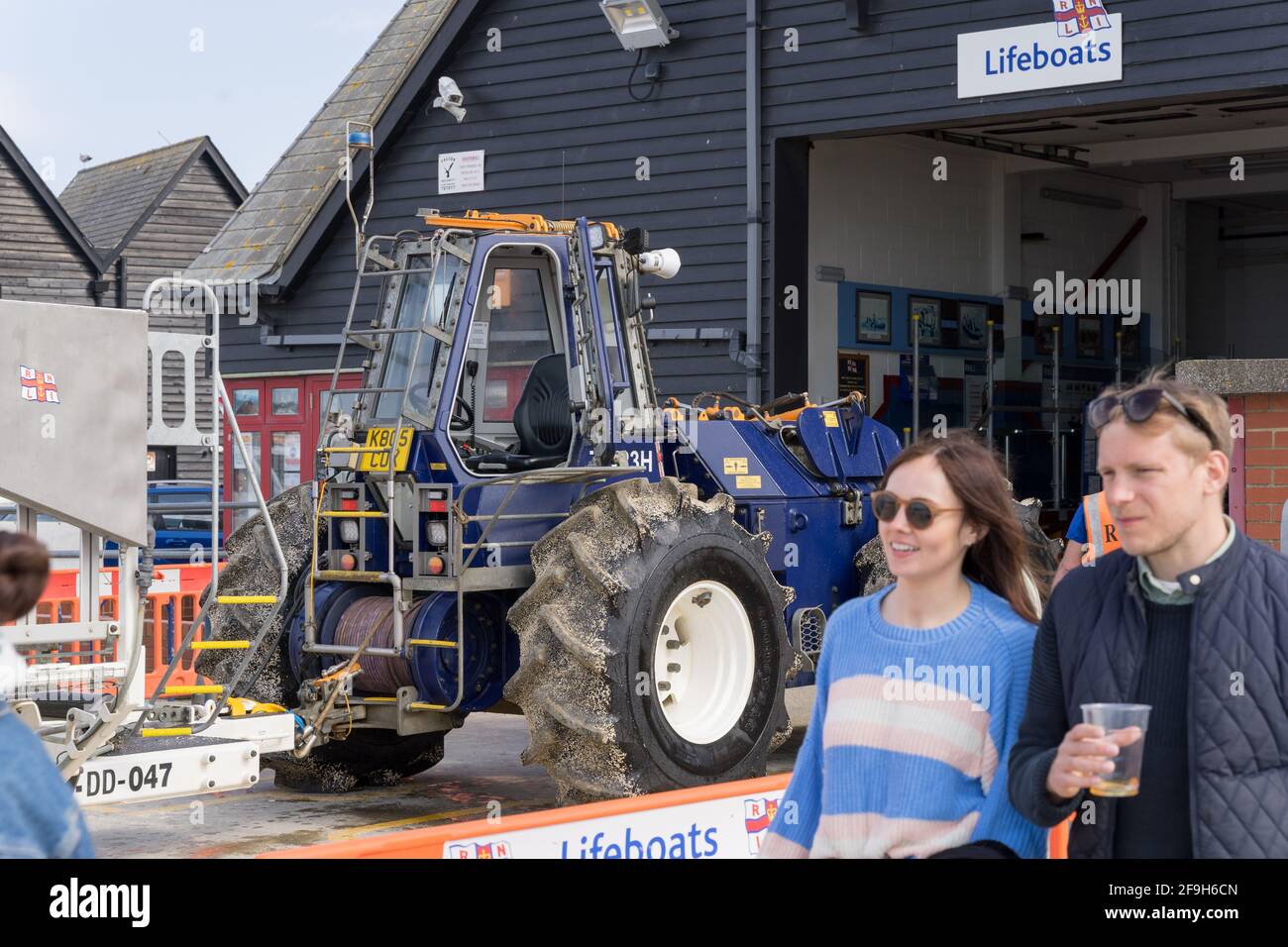 18th April 20201, woman and man with a pint beer in hand inspect the Lifeboat at Whitstable station launched on training Stock Photo