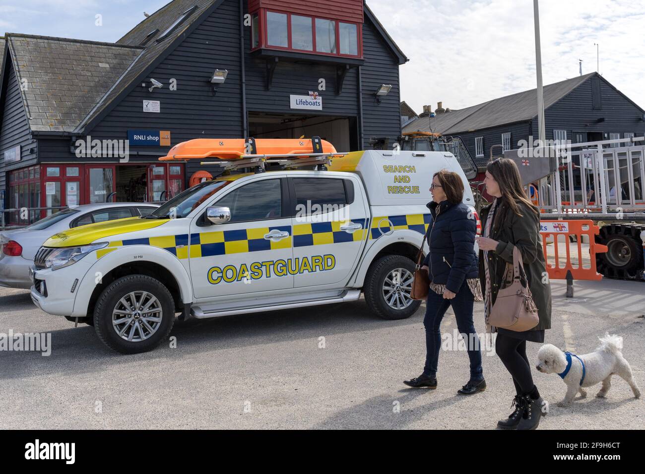 18th April 20201, two woman and dog visit the coastguard search and rescue van park outside Lifeboat Whitstable station, Kent Stock Photo