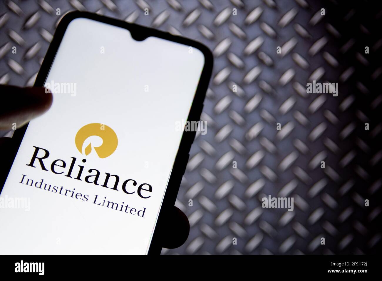 Greece. 18th Apr, 2021. In this photo illustration a Reliance Industries logo seen displayed on a smartphone screen with a computer wallpaper in the background. (Photo by Nikolas Joao Kokovlis/SOPA Images/Sipa USA) Credit: Sipa USA/Alamy Live News Stock Photo