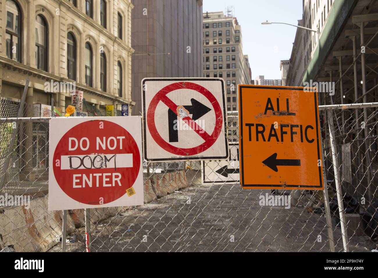Ttraffic signs posted on a fence closing off a cross street off Broadway in downtown Manhattan, New York City. Stock Photo