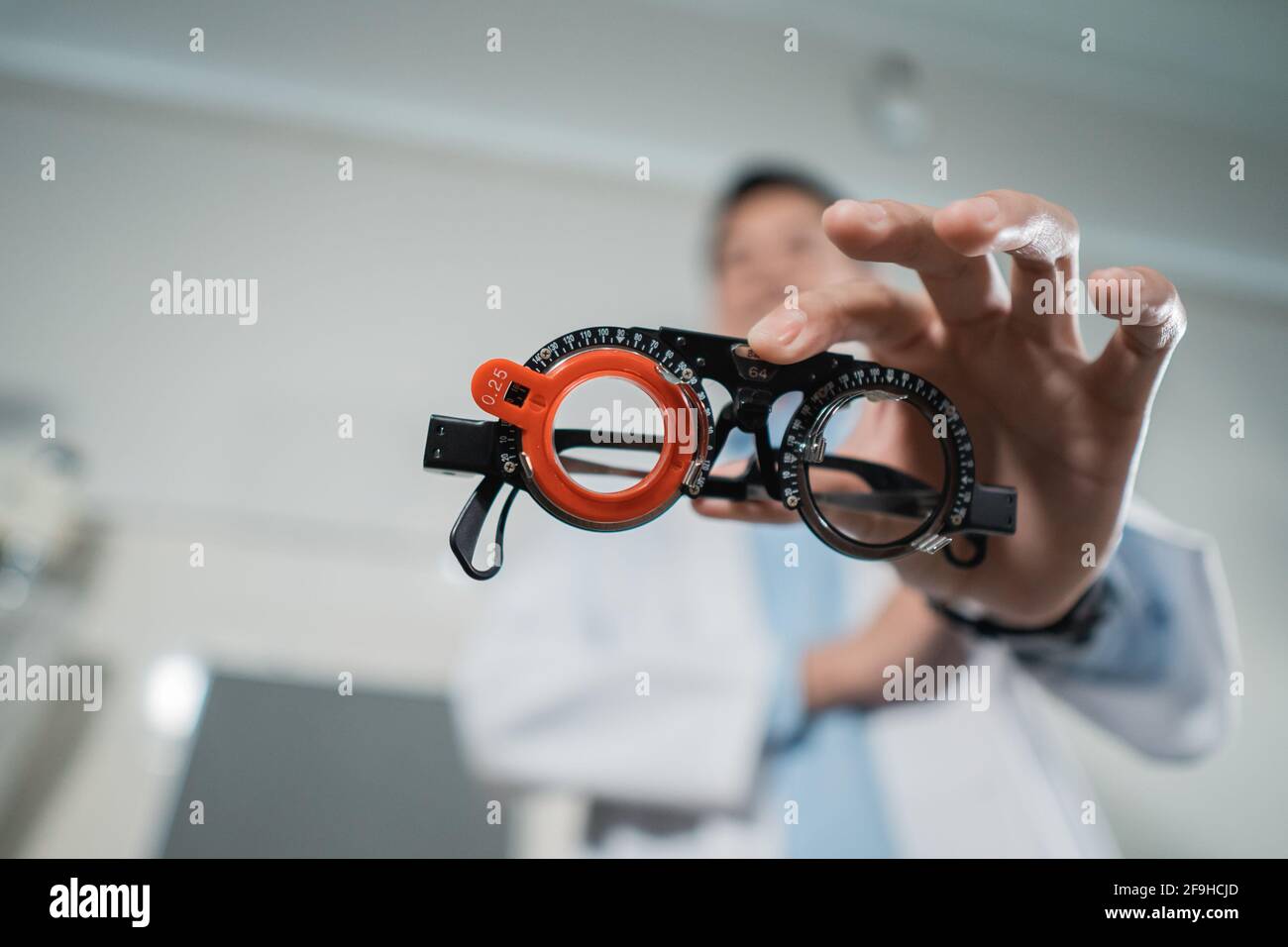 a trial frame is being held by a doctor Stock Photo