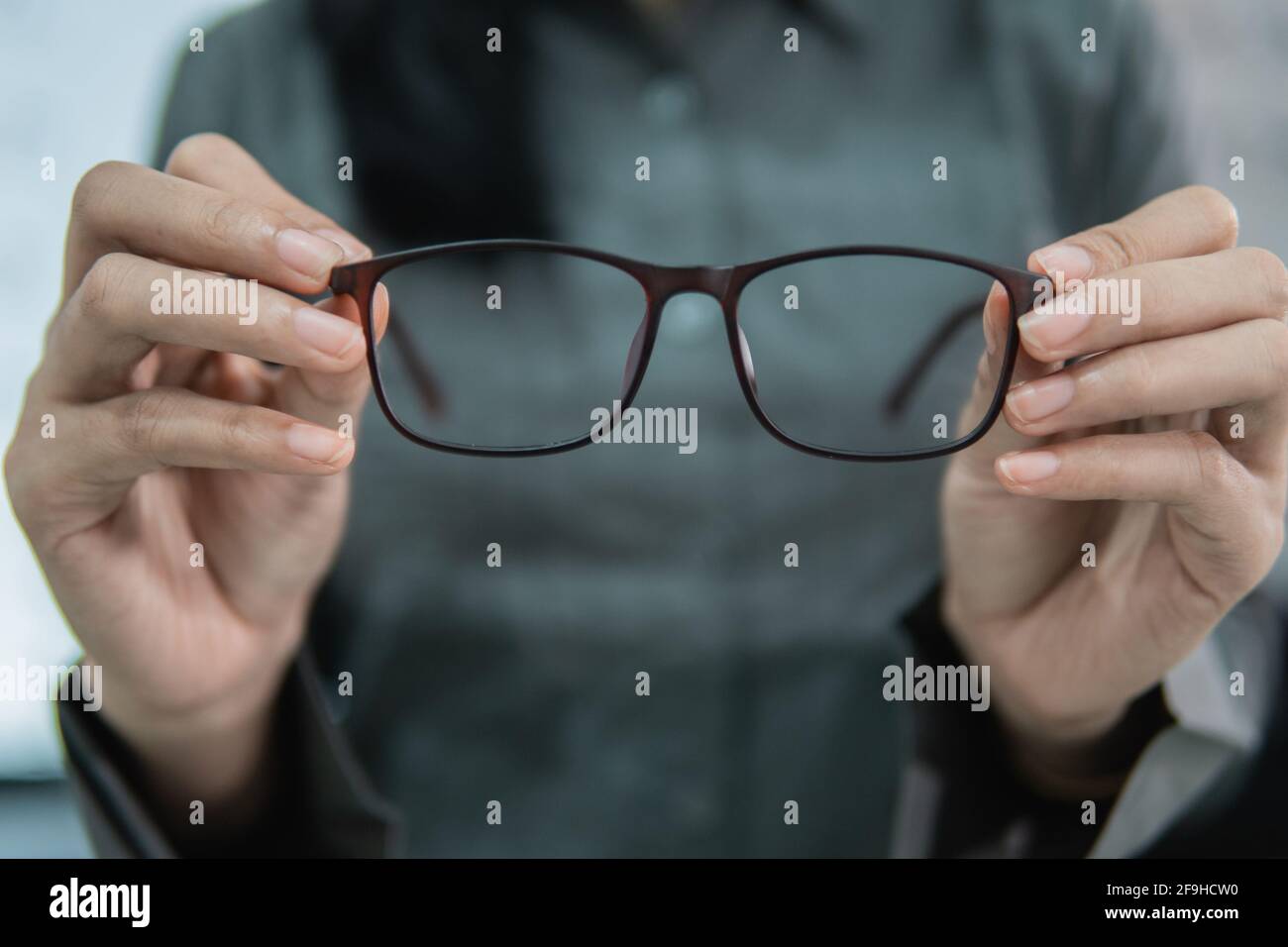a beautiful woman holding a sample of glasses Stock Photo