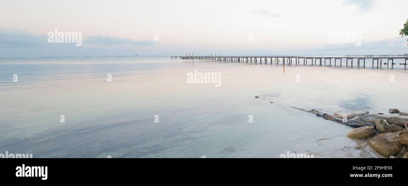 Early morning warf over calm seas on Isla Mujeres Mexico. Composite wide image Stock Photo