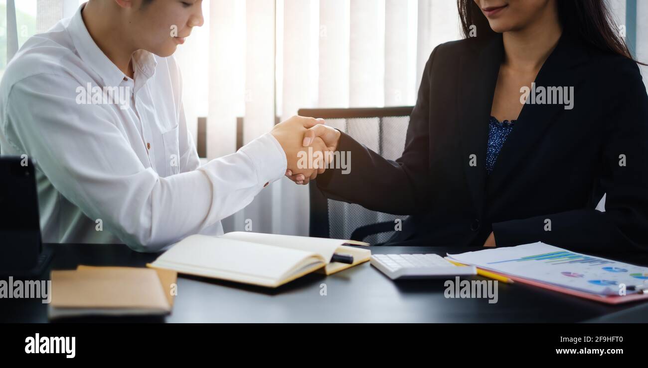 Finishing up meeting. Business and partners handshaking and agree make big project. Stock Photo