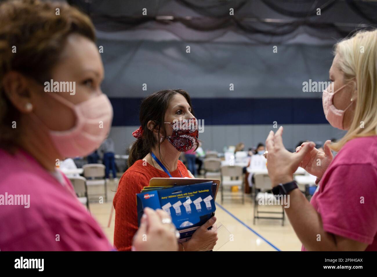 Cortney Marengo speaks to the other volunteers at a coronavirus disease (COVID-19) vaccine clinic run by Skippack Pharmacy in Lansdale, Pennsylvania, U.S., April 18, 2021. Marengo is the Volunteer Director of Operations at Skippack Pharmacy and volunteers over fifty hours a week. REUTERS/Hannah Beier Stock Photo
