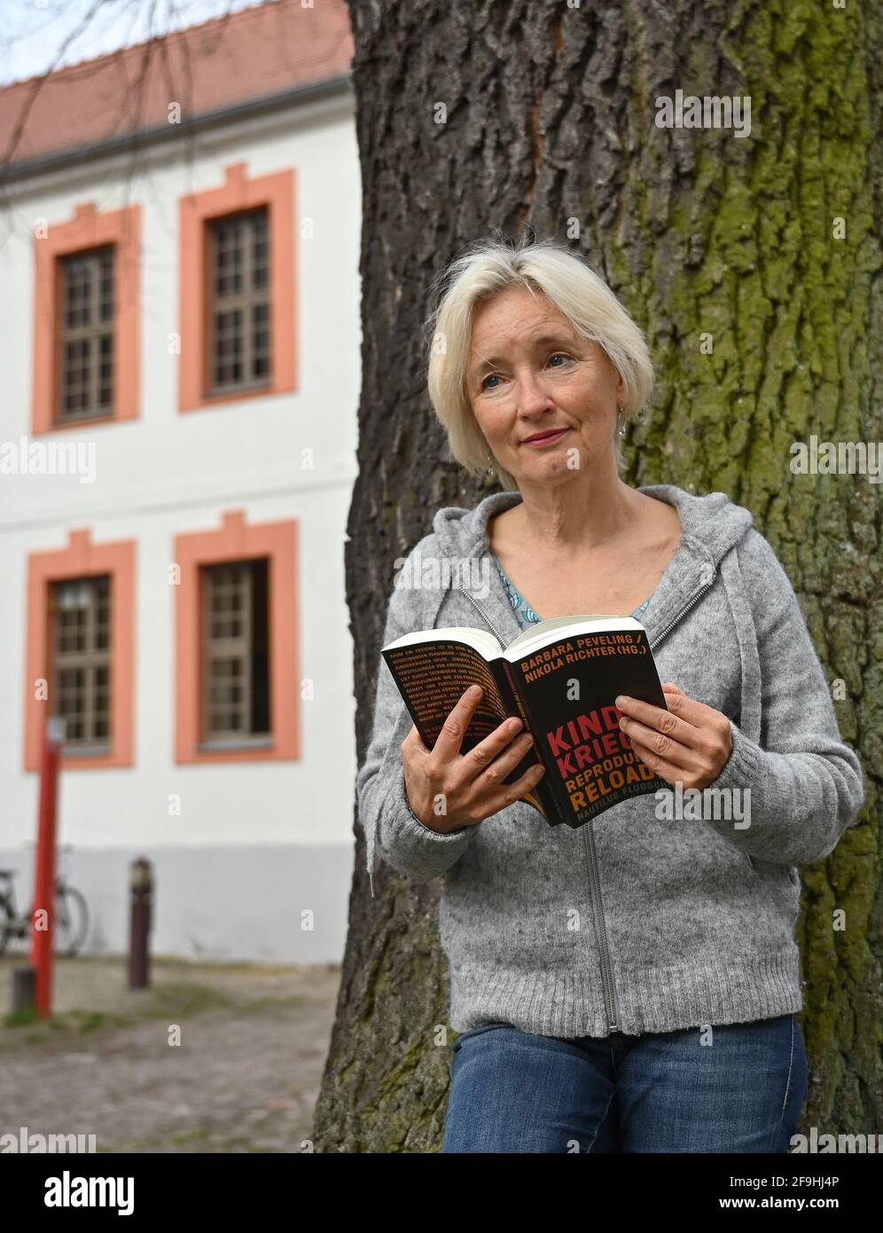 14 April 2021, Brandenburg, Beeskow: Martine Müller-Lombard, author, stands in the courtyard of Beeskow Castle. Since the beginning of January 2021, the new castle writer, Martine Müller-Lombard, has moved into Beeskow Castle. The Dresden native, who was selected by a jury from a good 50 applicants, has lived in France for many years. She learned about the call for entries through Mitteldeutscher Verlag, which published her debut novel 'Wir schenken uns nichts' in 2019. In Beeskow, Martine Müller-Lombard wants to work again on her short stories, for which a French publisher from Alsace is inte Stock Photo