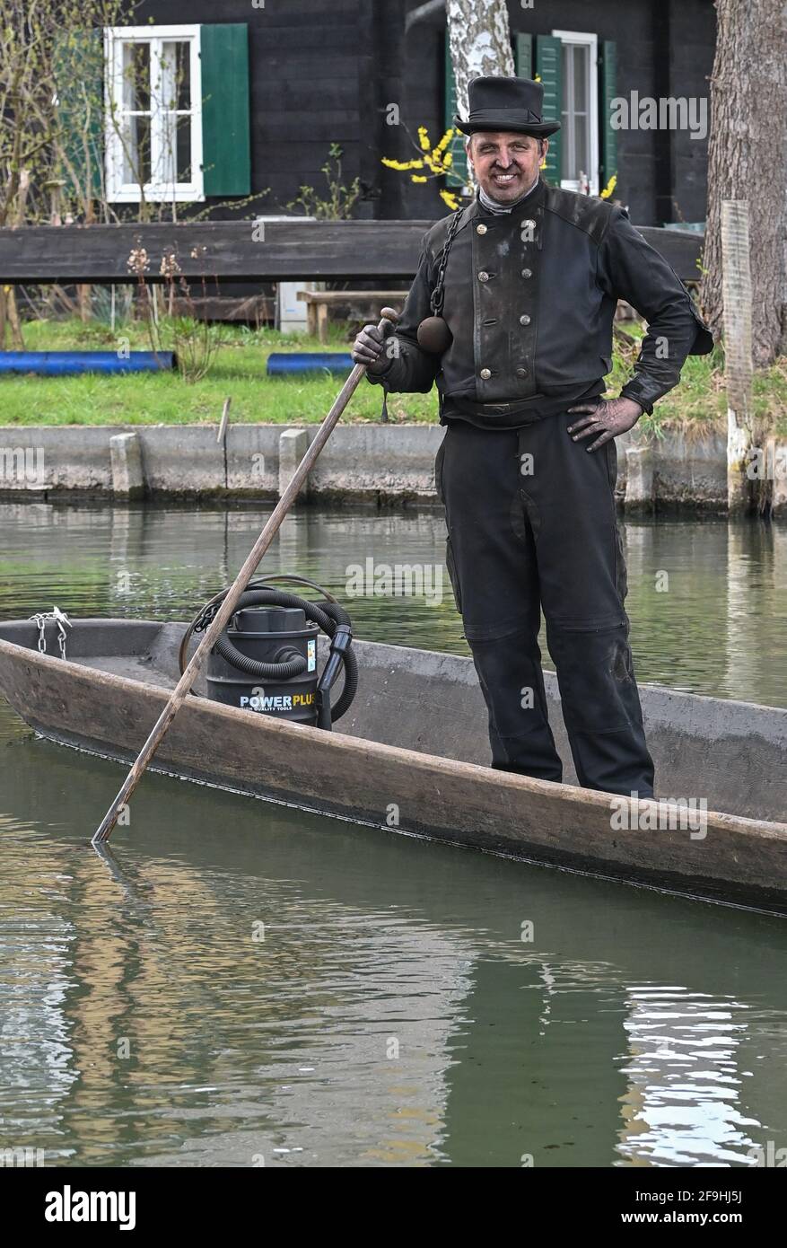 14 April 2021, Brandenburg, Lübbenau: The master chimney sweep Tino Winkler is standing in his barge on a river (waterway) in the Spreewald. Photo: Patrick Pleul/dpa-Zentralbild/ZB Stock Photo