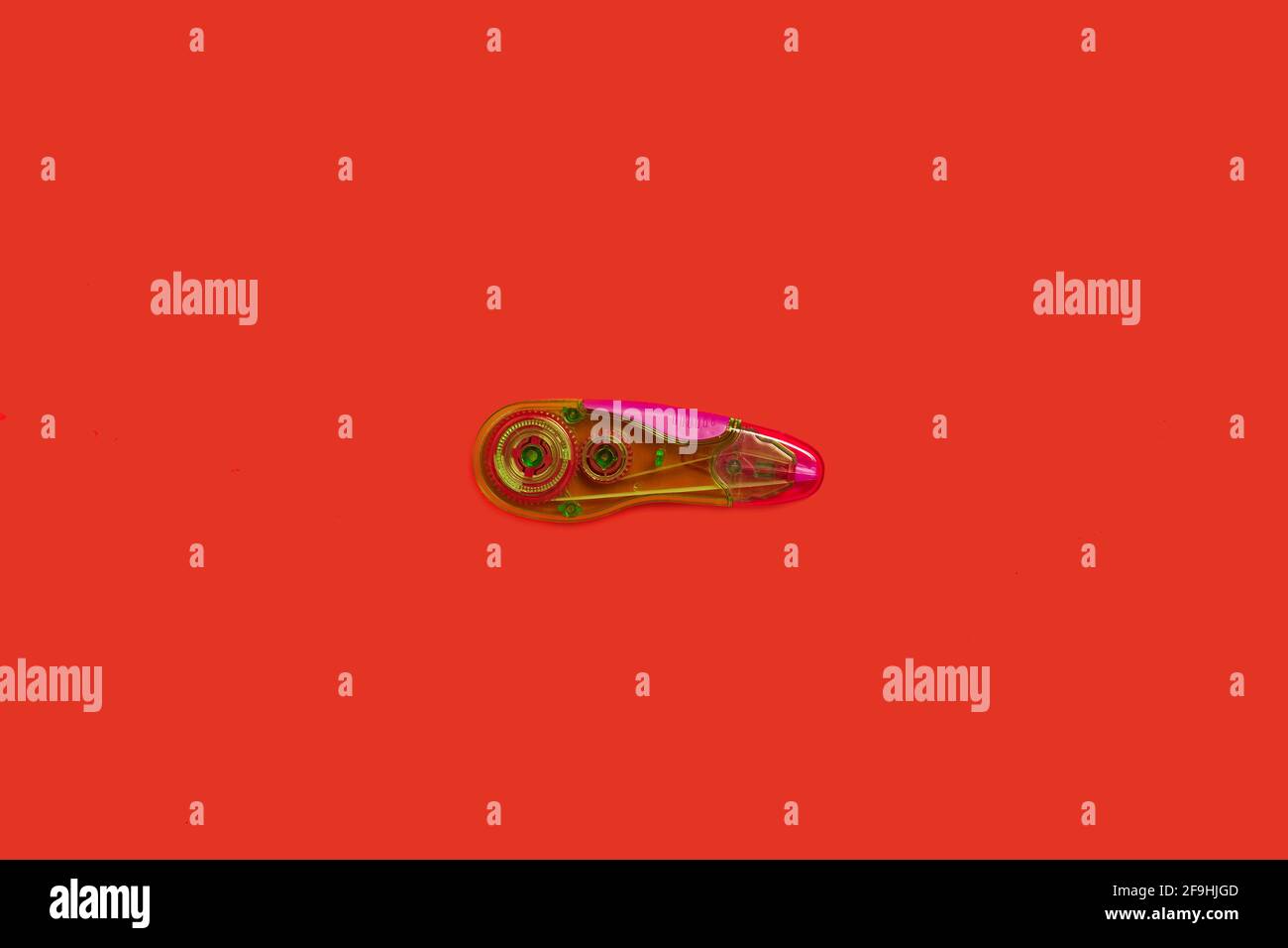 plastic tape corrector on a red background Stock Photo