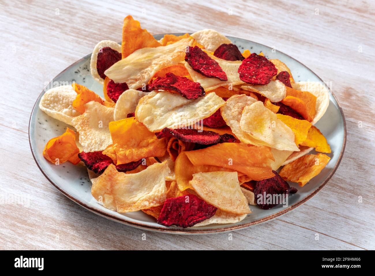 Vegetable chips on a plate, a healthy vegan snack Stock Photo