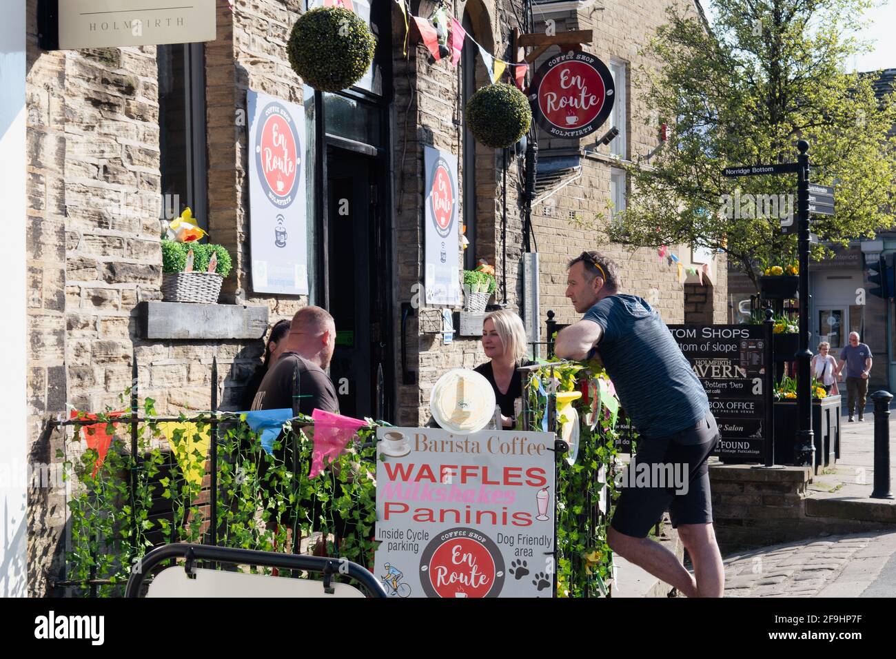 People meeting friends at independent coffee shop in the city centre of Holmfirth in West Yorkshire. End of Lockdown. Stock Photo