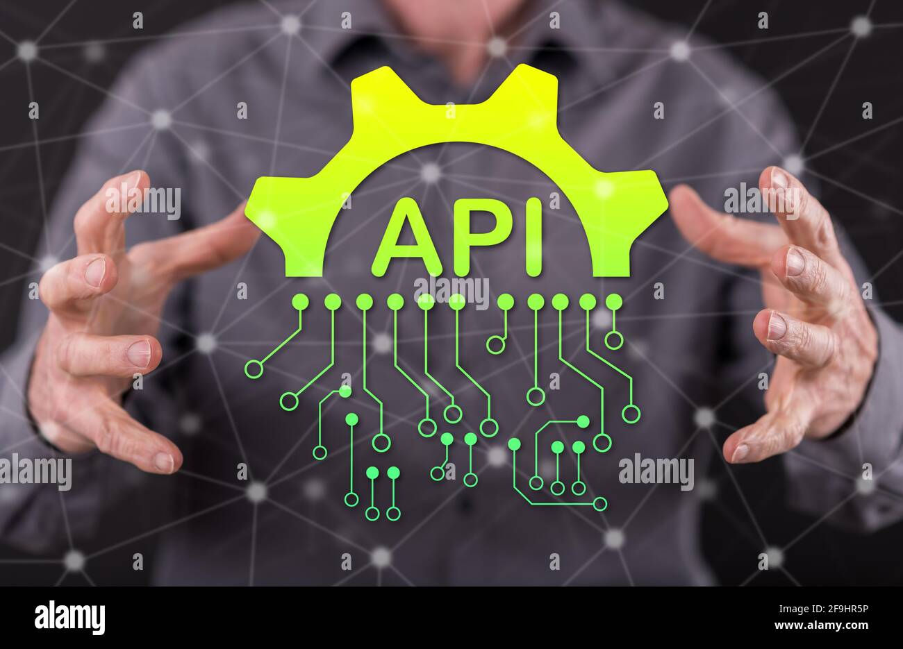 Api concept between hands of a man in background Stock Photo