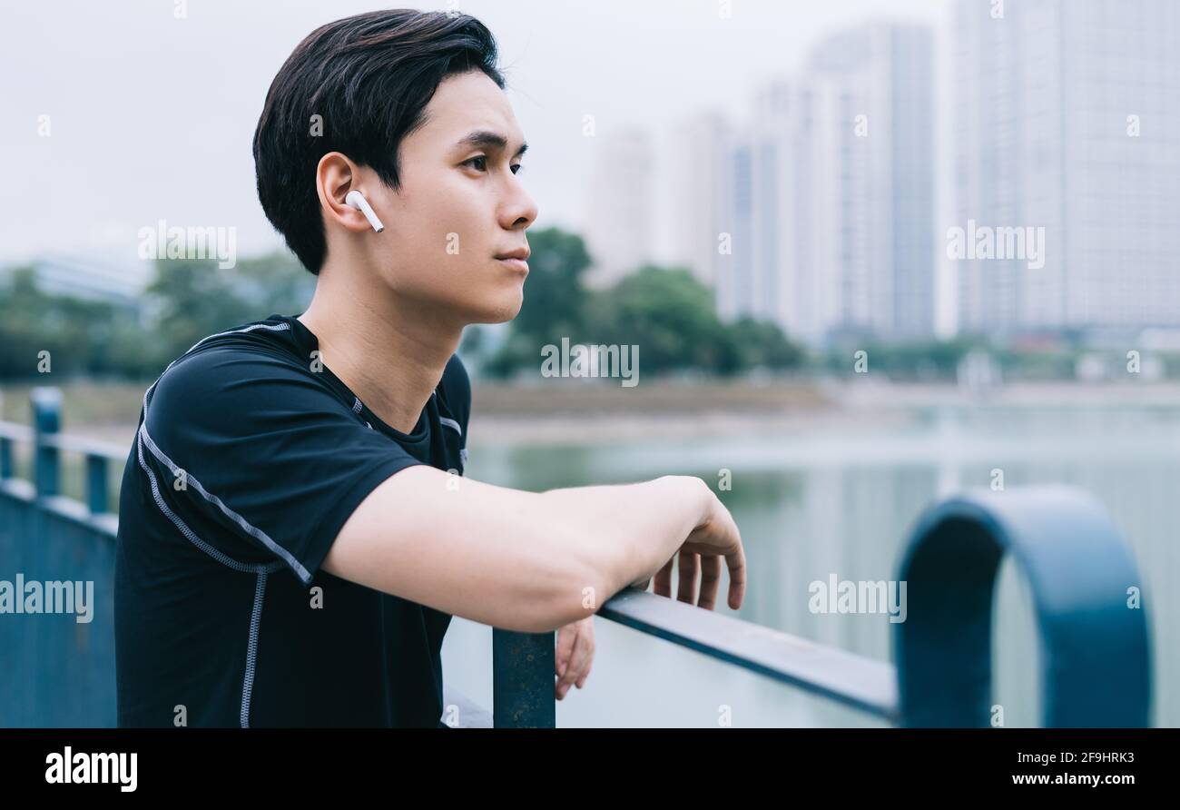 Young Asian man is resting after the practice session Stock Photo