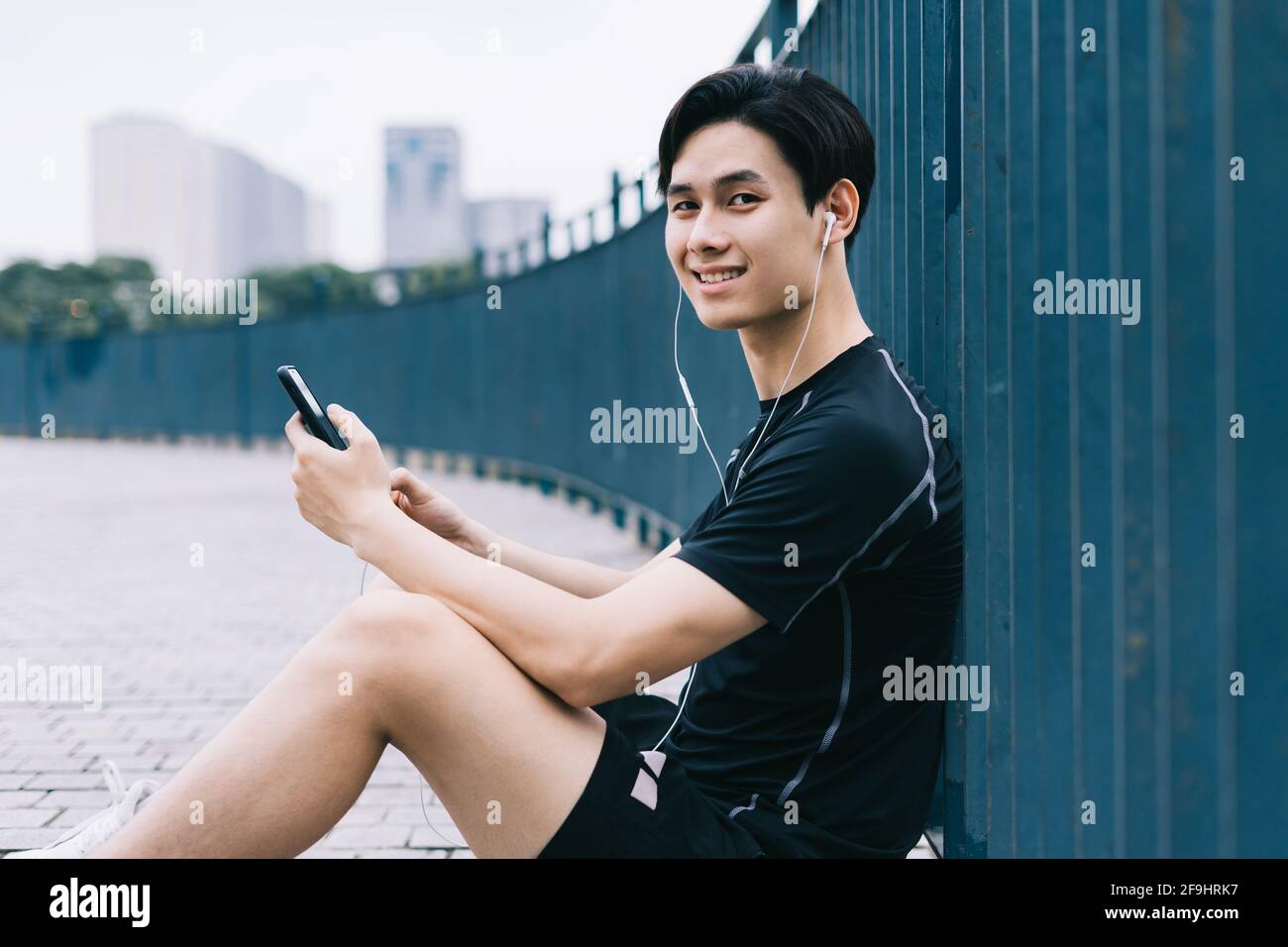 Young Asian man is resting after the practice session Stock Photo