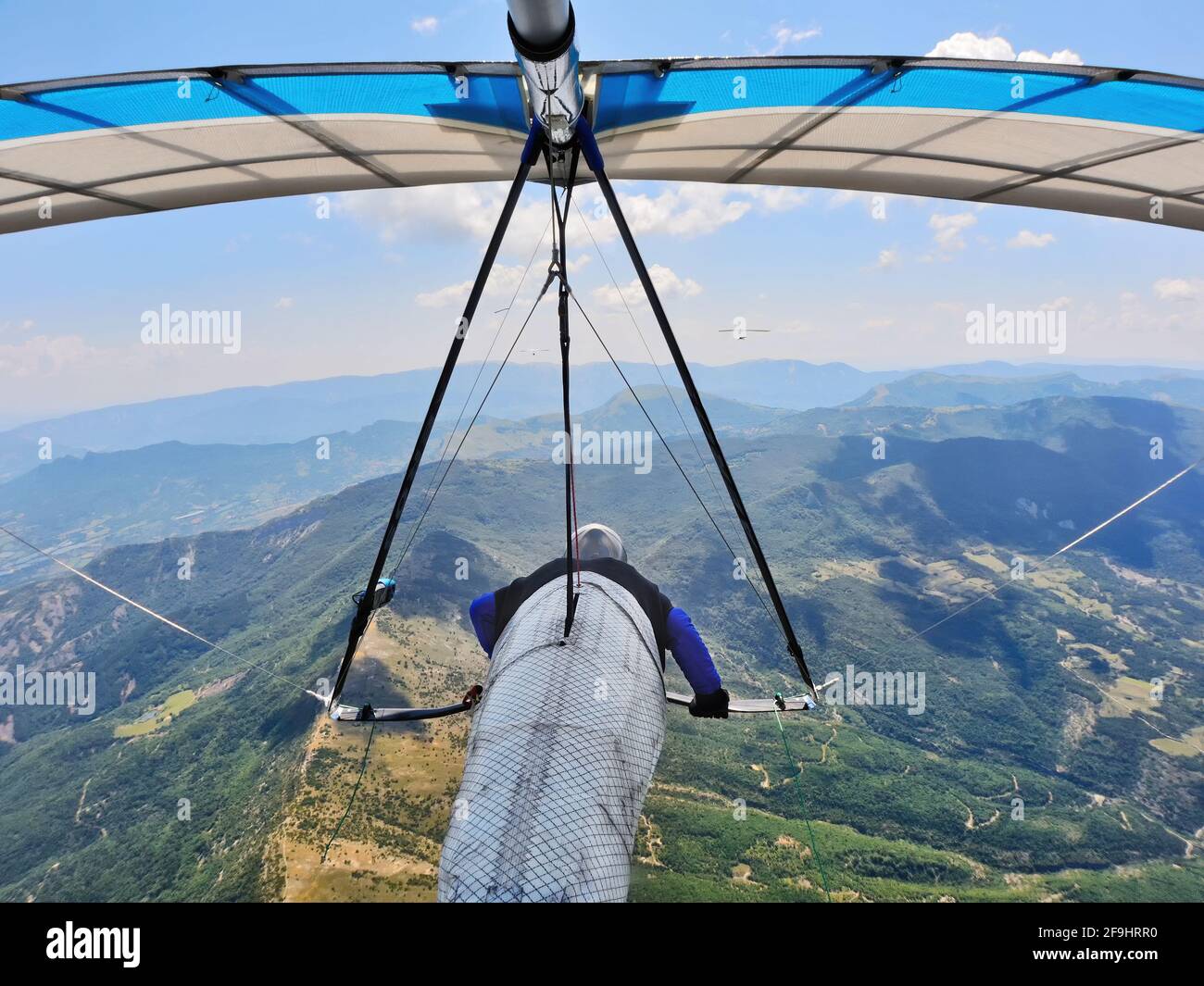 Hang glider pilots race on high altitude above mountain ridges. Extreme sports Stock Photo