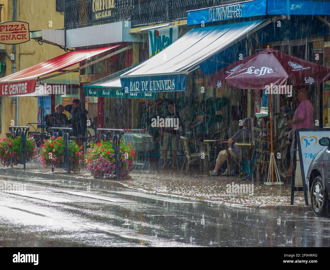 July 19, 2020. Laragne-Monteglin, France. Strong rain on the streets of small town. People are hiding in the shops and cafes. Rainy weather forecast Stock Photo
