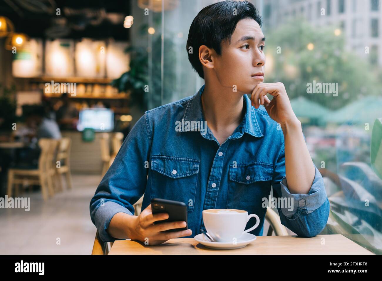 Asian man working at cafe on weekend Stock Photo