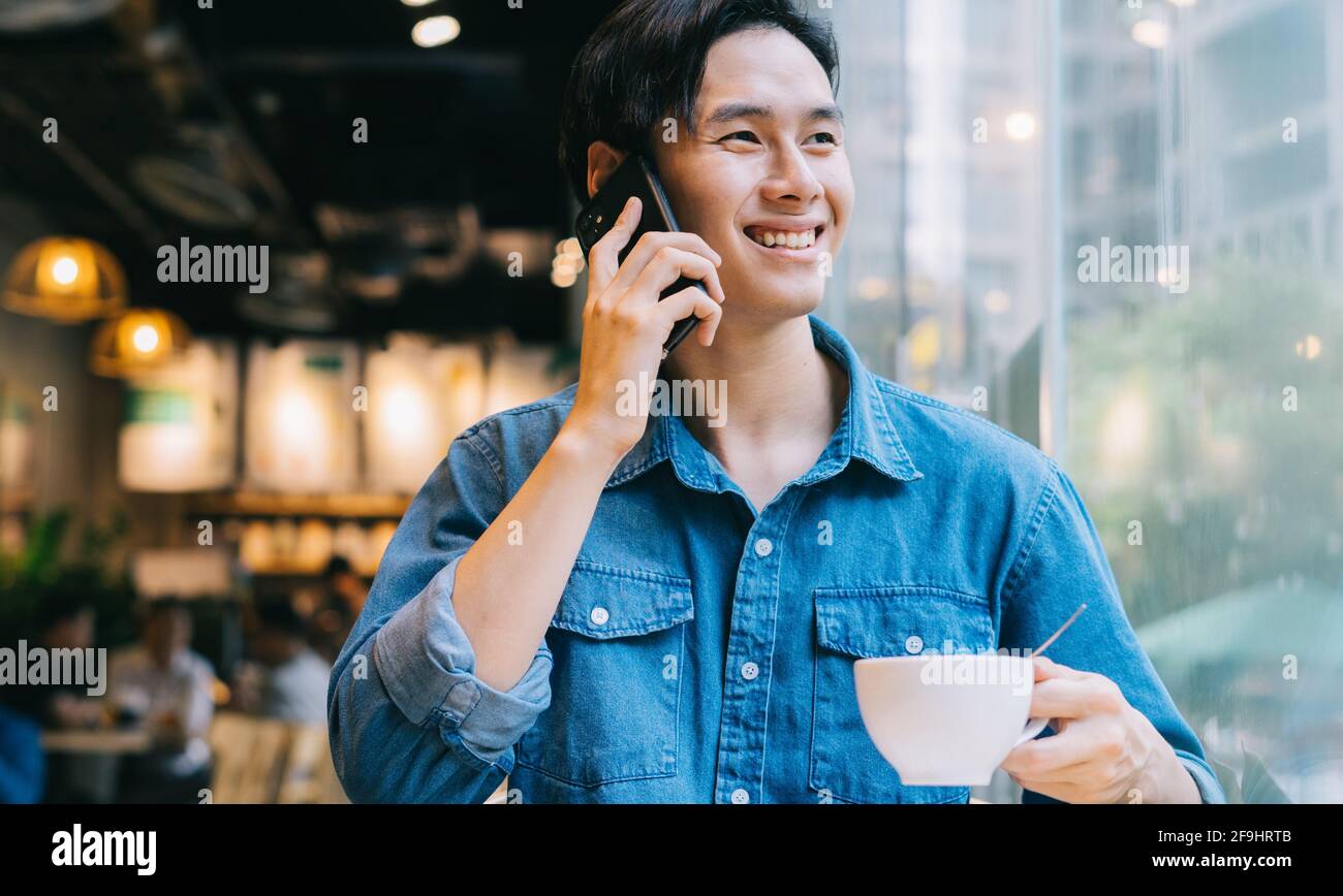 Asian man working at cafe on weekend Stock Photo