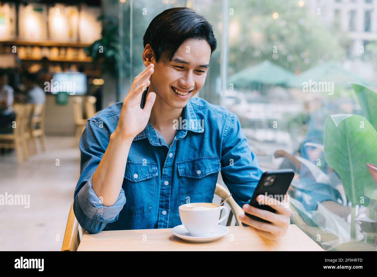 Asian man working at cafe on weekend Stock Photo