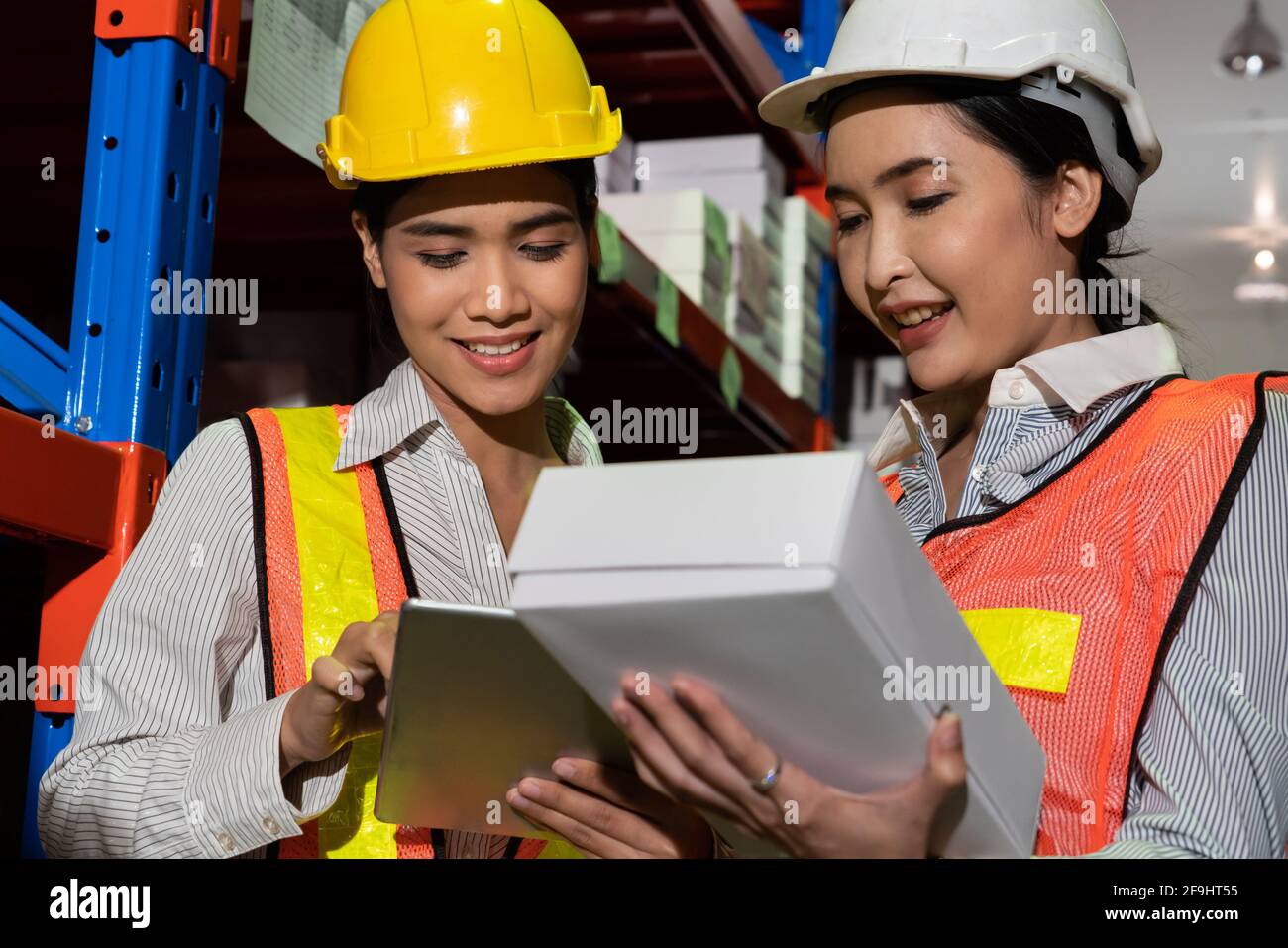 Female warehouse worker working at the storehouse . Logistics , supply