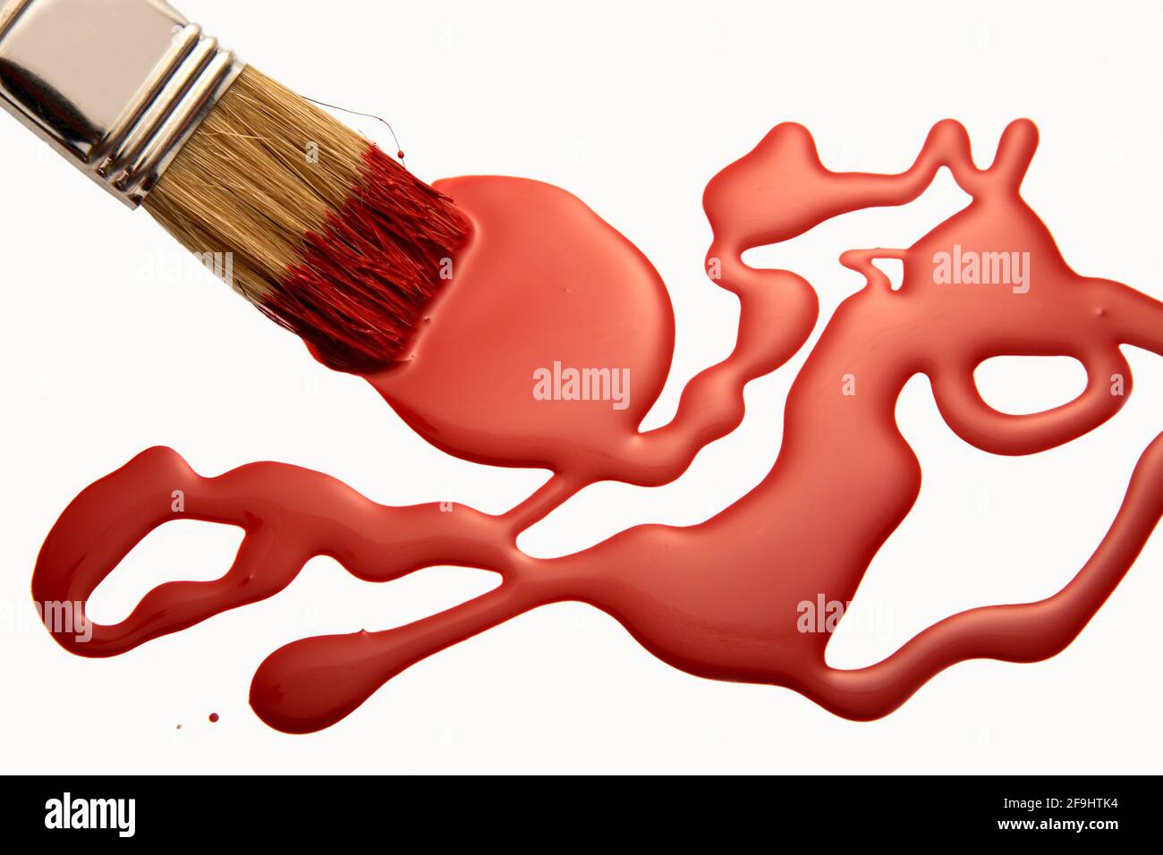 red paint with brush on white background Stock Photo